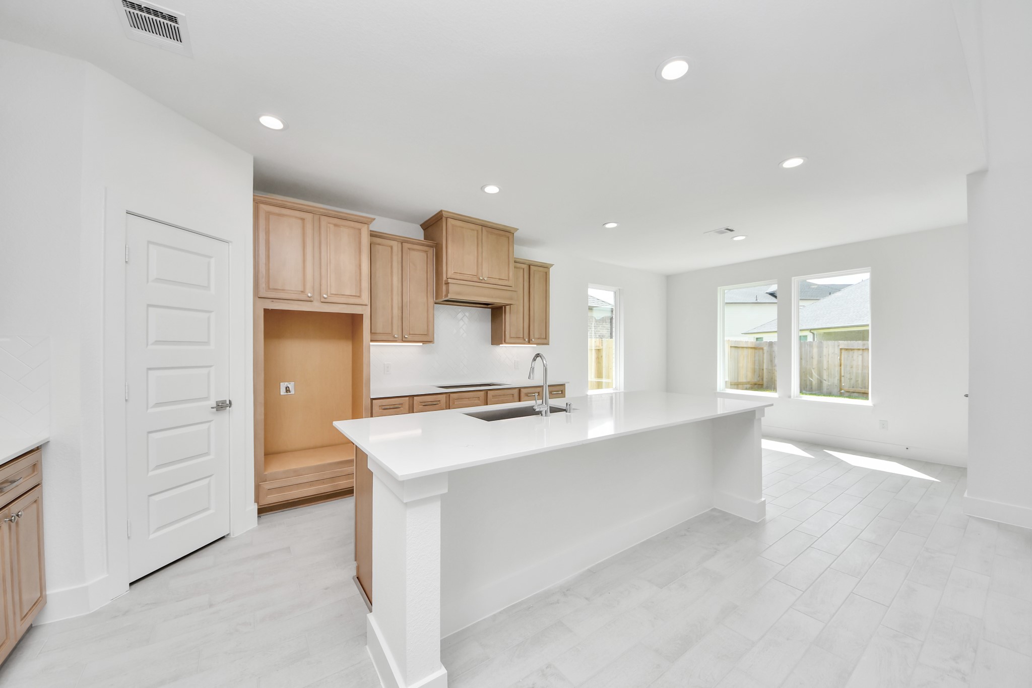 The kitchen is a culinary haven, featuring granite countertops, a tile backsplash, stainless steel appliances, 42 upper cabinets, and undercabinet lighting. Sample photo of completed home with similar floor plan. Actual colors and selections may vary.