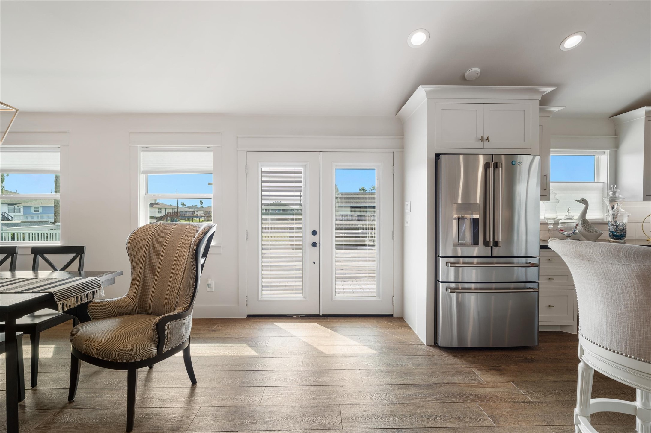 View as you enter the home, looking out towards the water side. Notice the stunning luxury vinyl plank flooring throughout the entire home