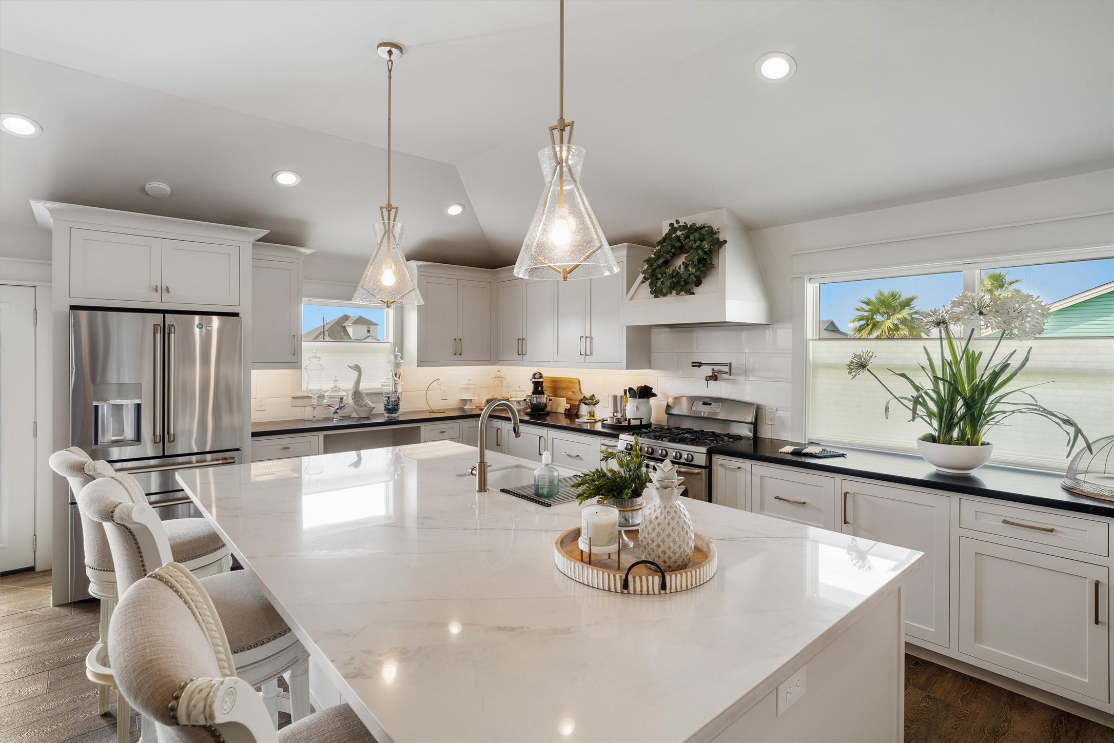 The enormous island can sit many people and is the perfect spot for friends and family to relax while the chef of the family is cooking