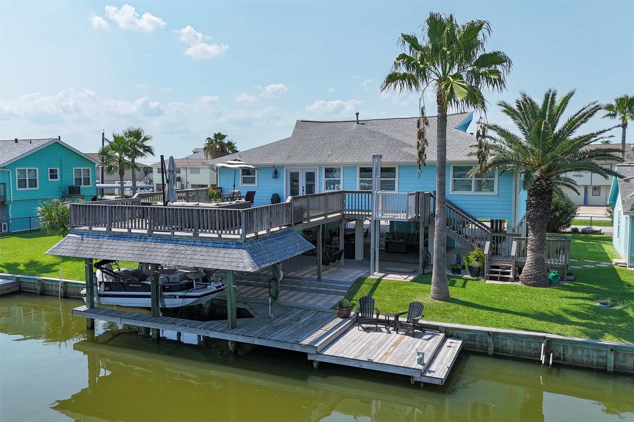 The water side of the home boasts stunning views and direct access to the canal, framed by lush landscaping and a spacious deck perfect for relaxing or entertaining. Large windows and open spaces invite natural light and gentle breezes, creating a serene waterfront retreat where every day feels like a vacation The water side of the home boasts stunning views and direct access to the canal, framed by lush landscaping and a spacious deck perfect for relaxing or entertaining. Large windows and open spaces invite natural light and gentle breezes, creating a serene waterfront retreat where every day feels like a vacation