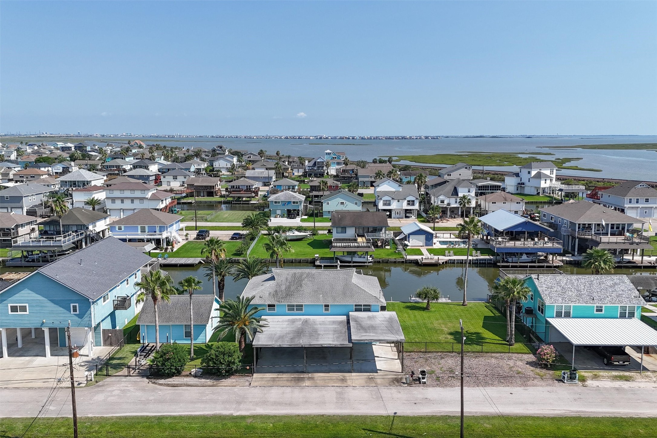 Aerial view from the street side showing you the 3 lots including the garage, home, and empty lot