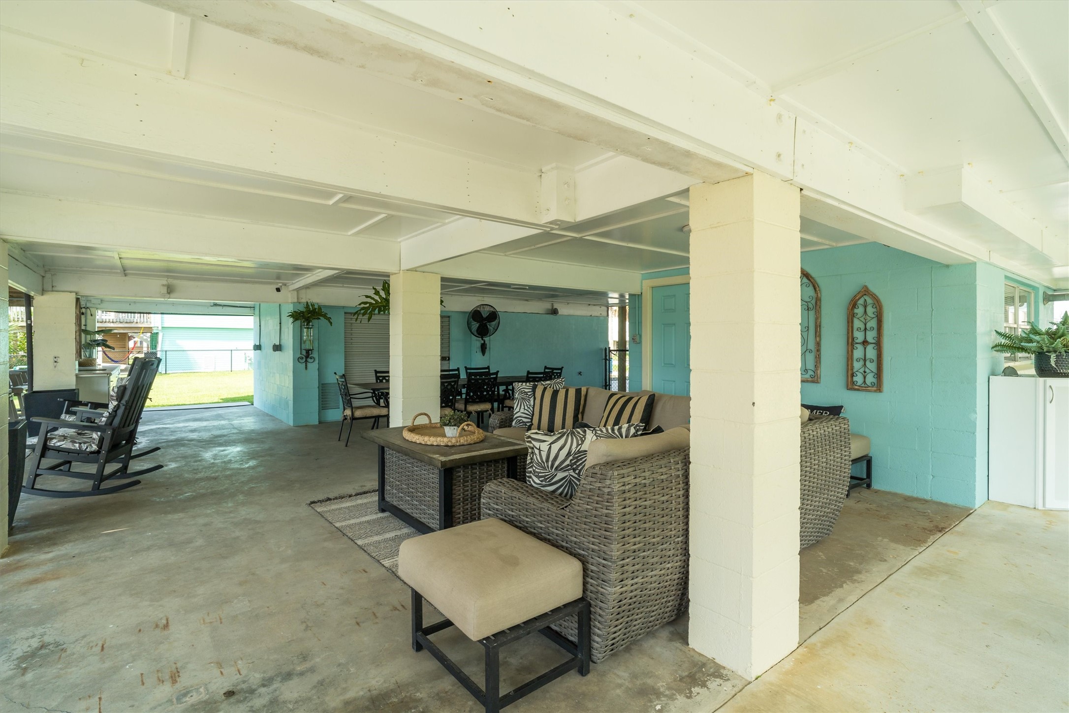 The downstairs features a shady entertaining area, perfect for relaxing out of the sun, along with an open space ideal for gatherings, games, or enjoying the fresh air. This versatile setup offers options for both cool comfort and outdoor fun