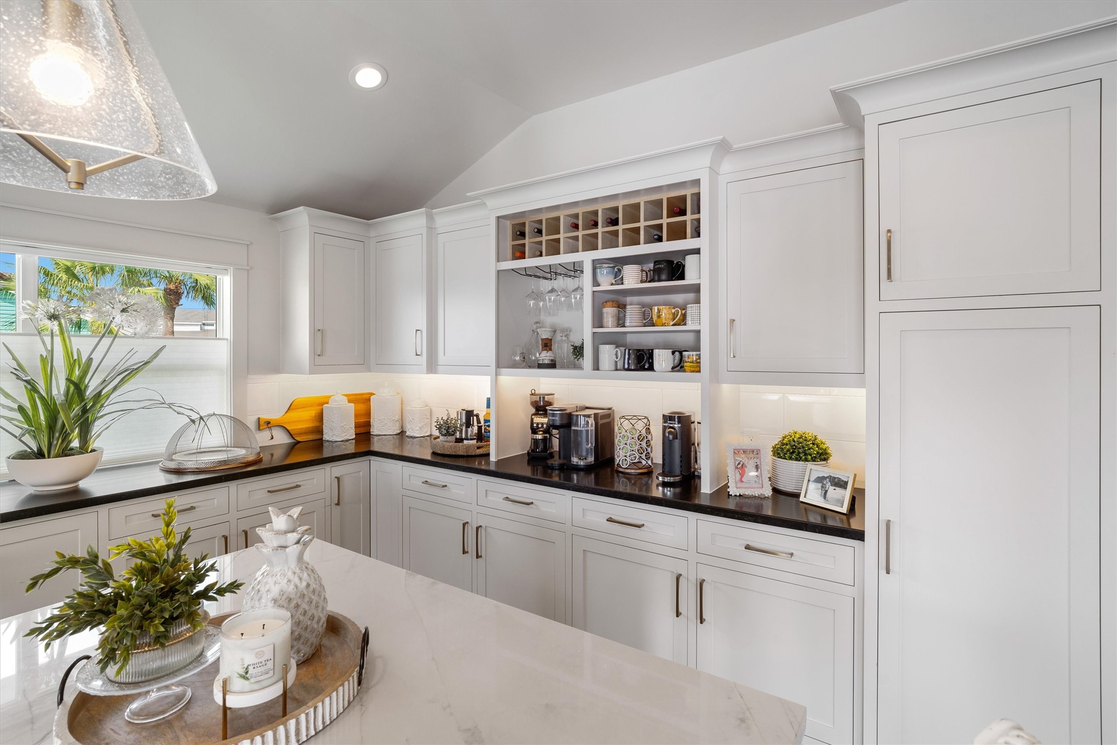 The custom white cabinets with stylish contrasting countertops add a modern touch to the kitchen. There is no lack of storage with these soft close cabinets and drawers The custom white cabinets with stylish contrasting countertops add a modern touch to the kitchen. There is no lack of storage with these soft close cabinets and drawers