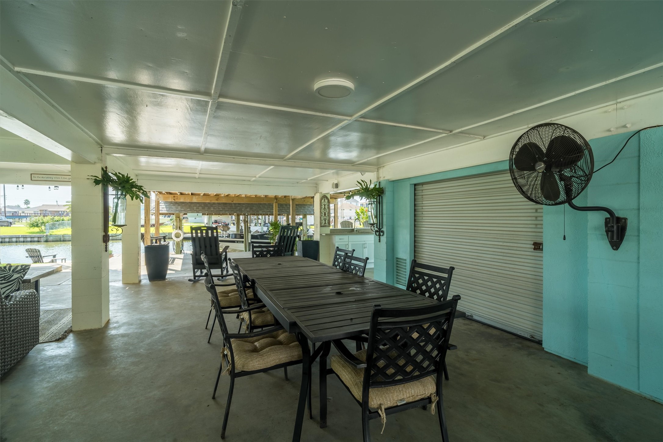 More downstairs entertaining area. Behind the small garage type door is a large storage room
