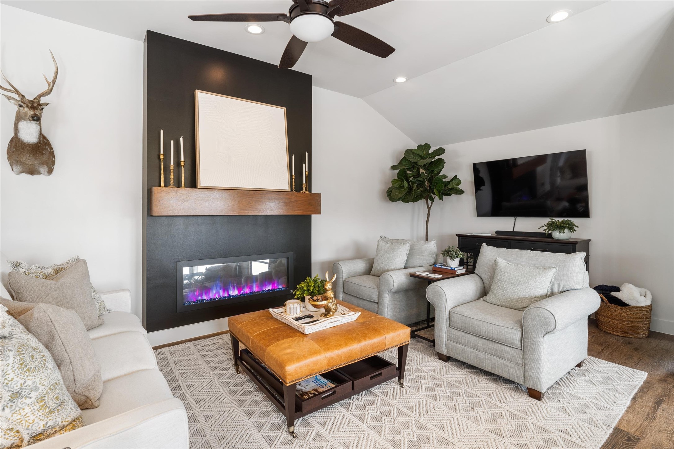 The electric fireplace is a show stopper in the living area. The ceiling height is very noticeable in this picture. Raising the ceiling height is one of the many updates the sellers added