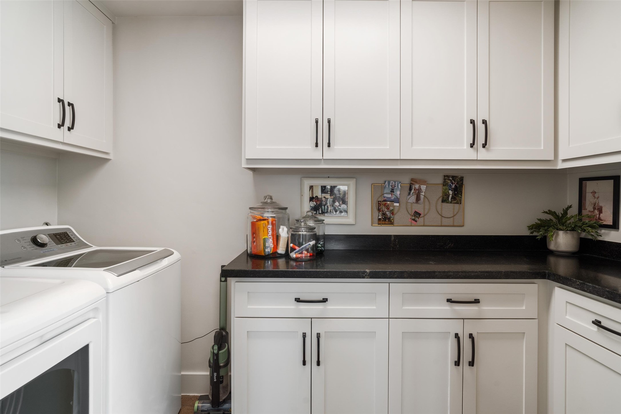 Upstairs, a spacious laundry room offers built-in storage, providing plenty of space and convenience for all your laundry needs
