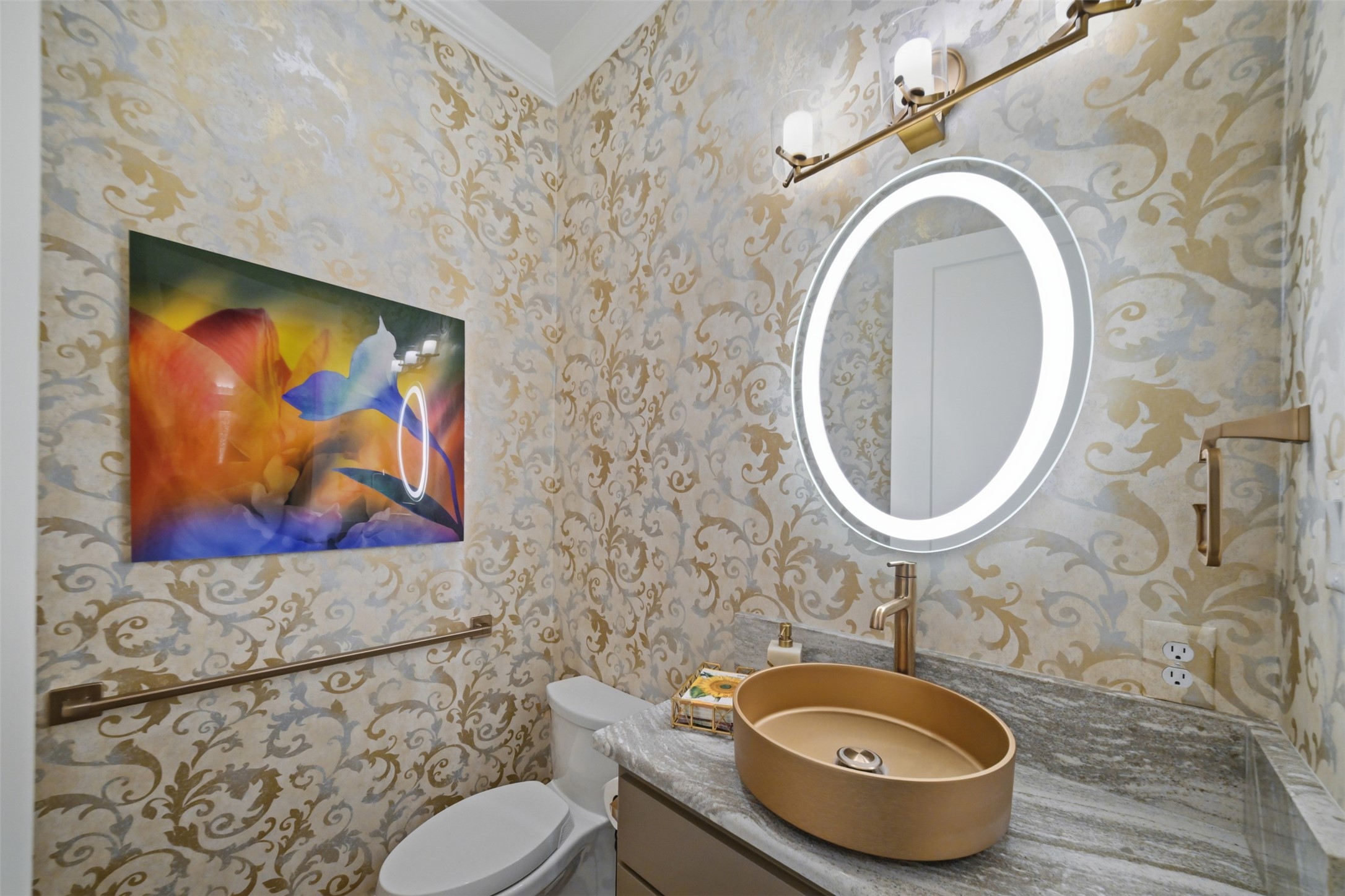 Stylish powder room featuring a custom vessel sink, illuminated mirror and designer fixtures.