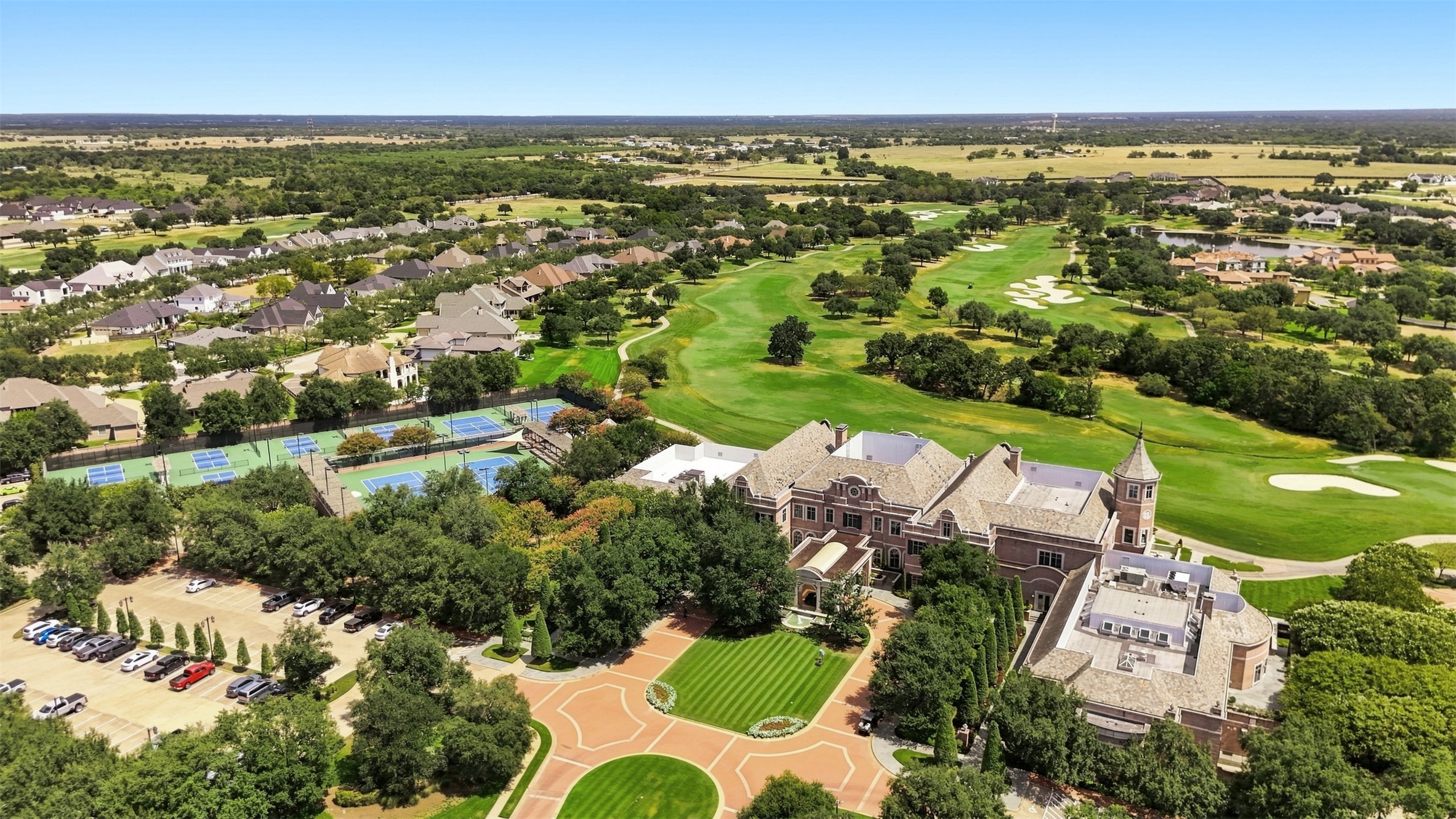 Aerial view of Miramont Country Club showcasing the clubhouse, golf course, tennis courts, and pickleball courts.