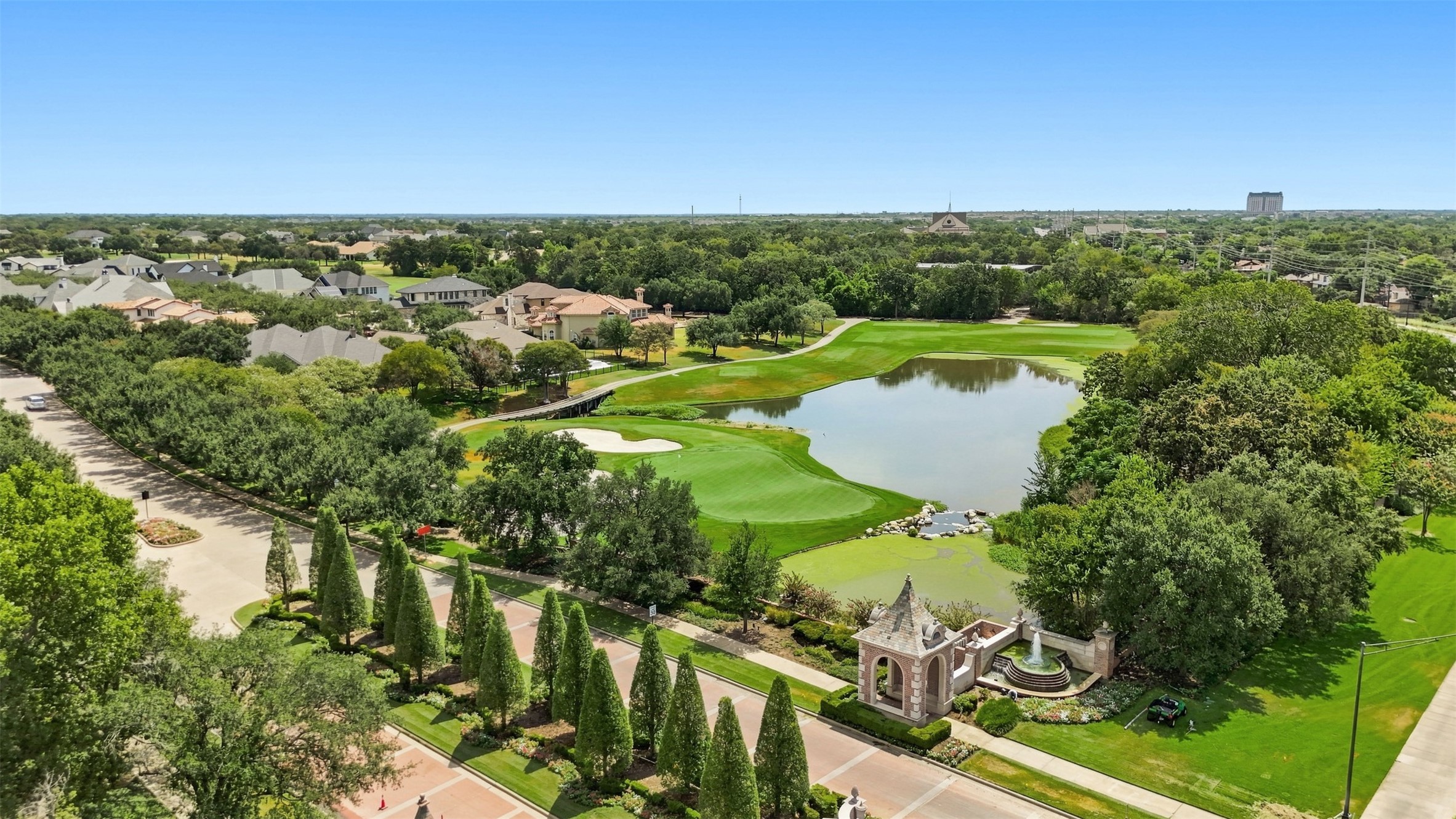 Aerial view showcasing the beautifully maintained Miramont community, picturesque golf course, and water features.