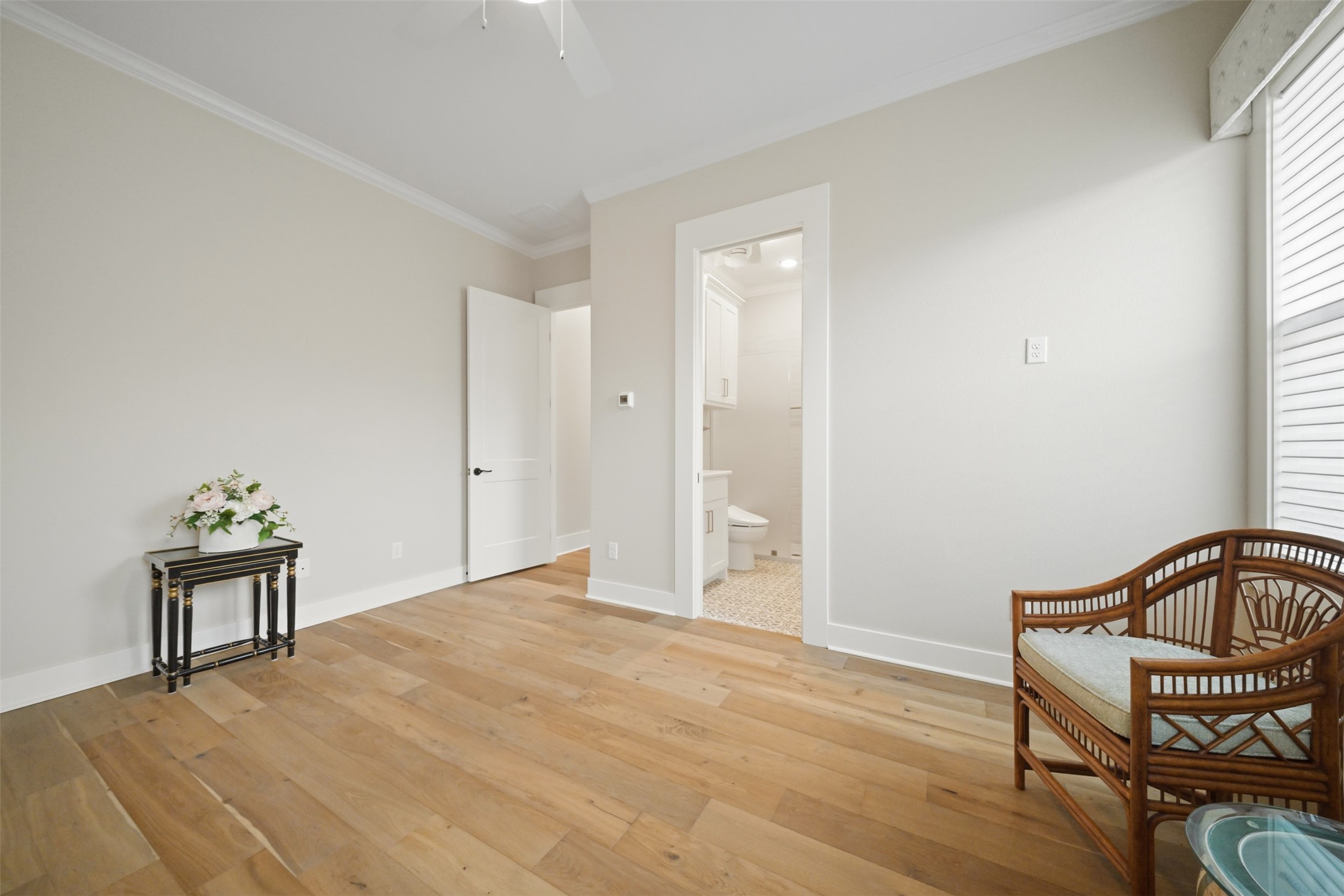 Secondary bedroom with en suite bath, hardwood flooring and remote-controlled custom window shades.