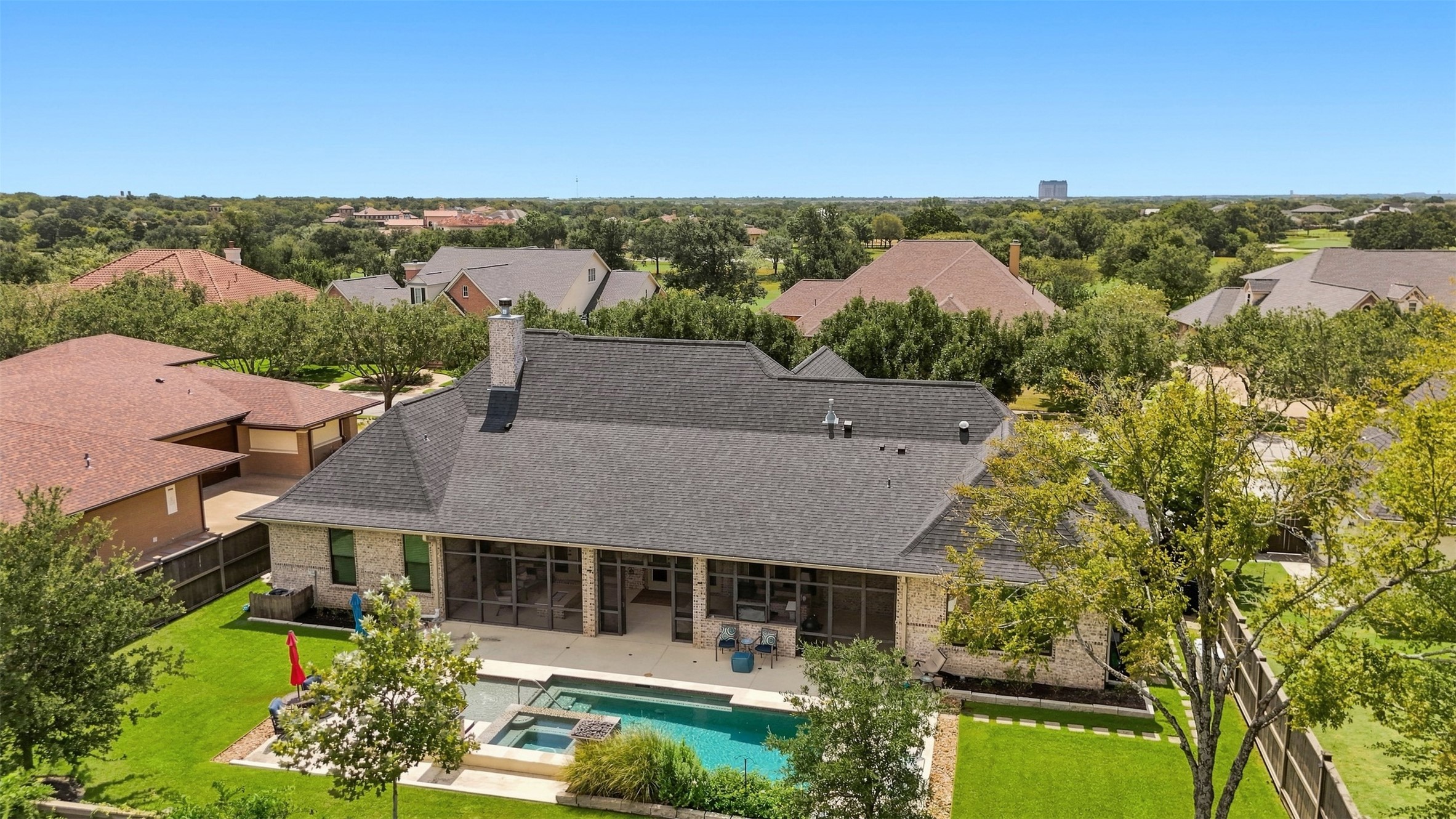 Pool and patio area offering multiple spaces for lounging, dining, and relaxing, with the screened porch just steps away.