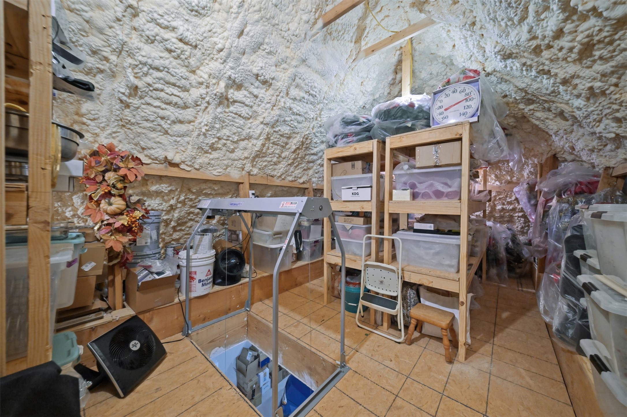 Impressive temperature-controlled attic storage with spray foam insulation, stationary stair access and a Versa Lift for easily moving heavier items.
