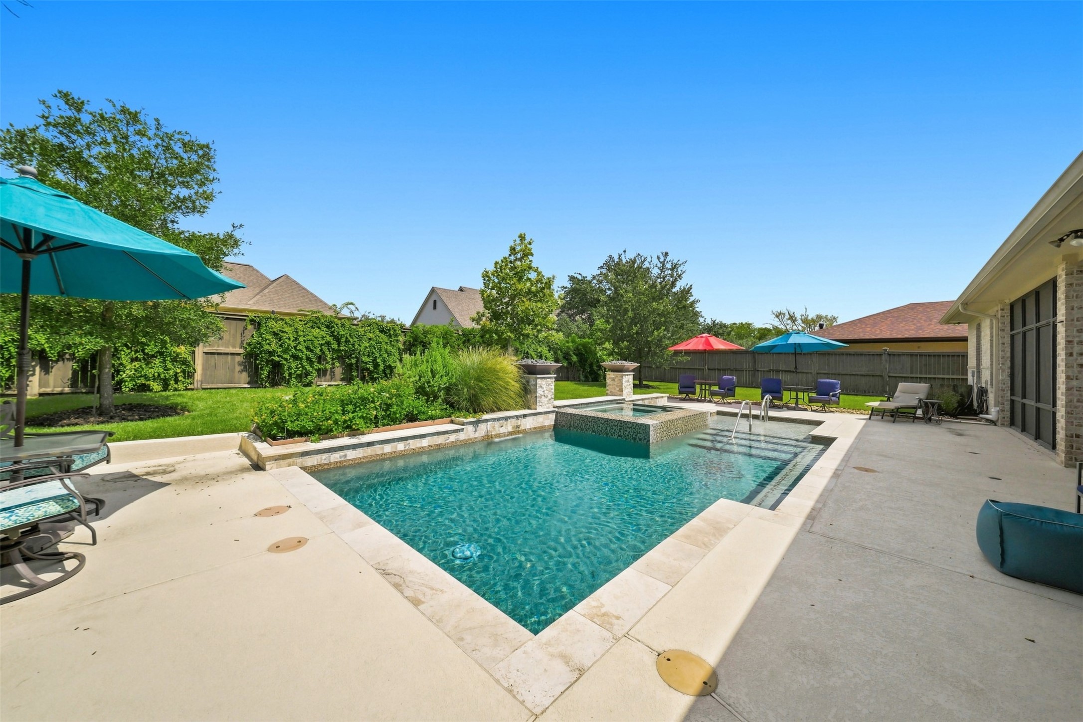 Resort-style heated pool and spa create a private backyard retreat.