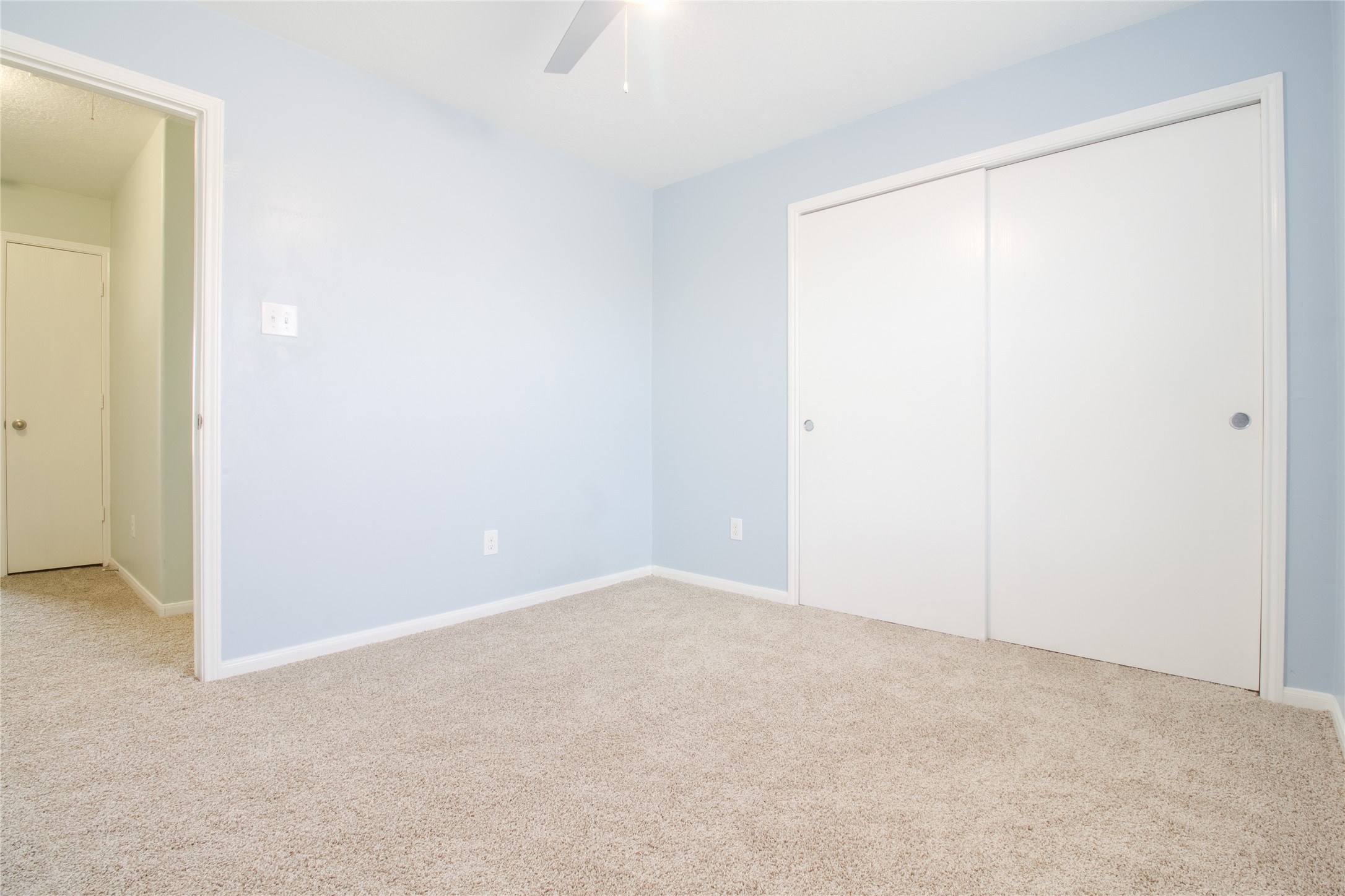 Bedroom 2 is conveniently located on the left side of the hallway and features brand-new carpet.