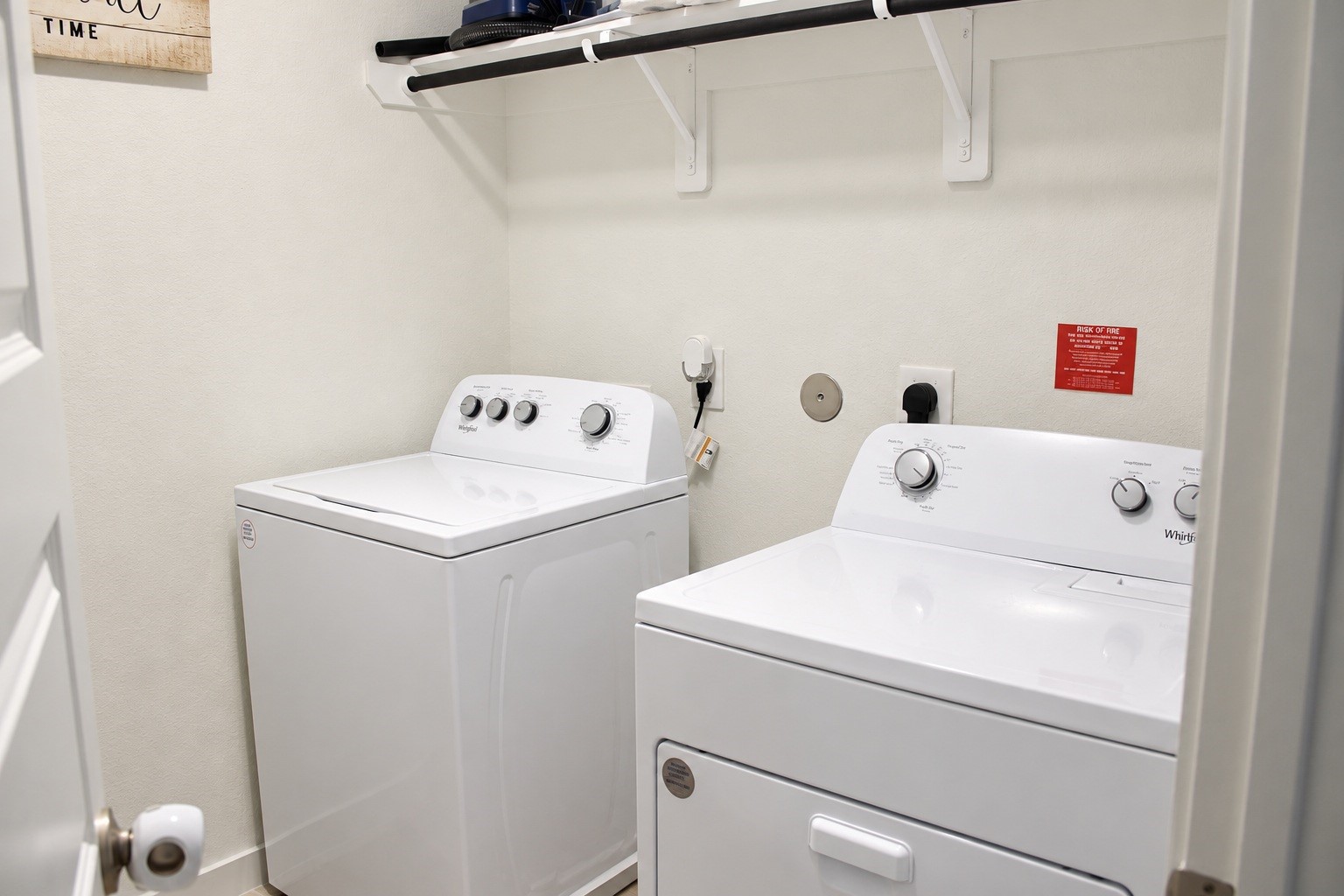 Laundry Room with Washer, Dryer, and Overhead Storage Shelving.