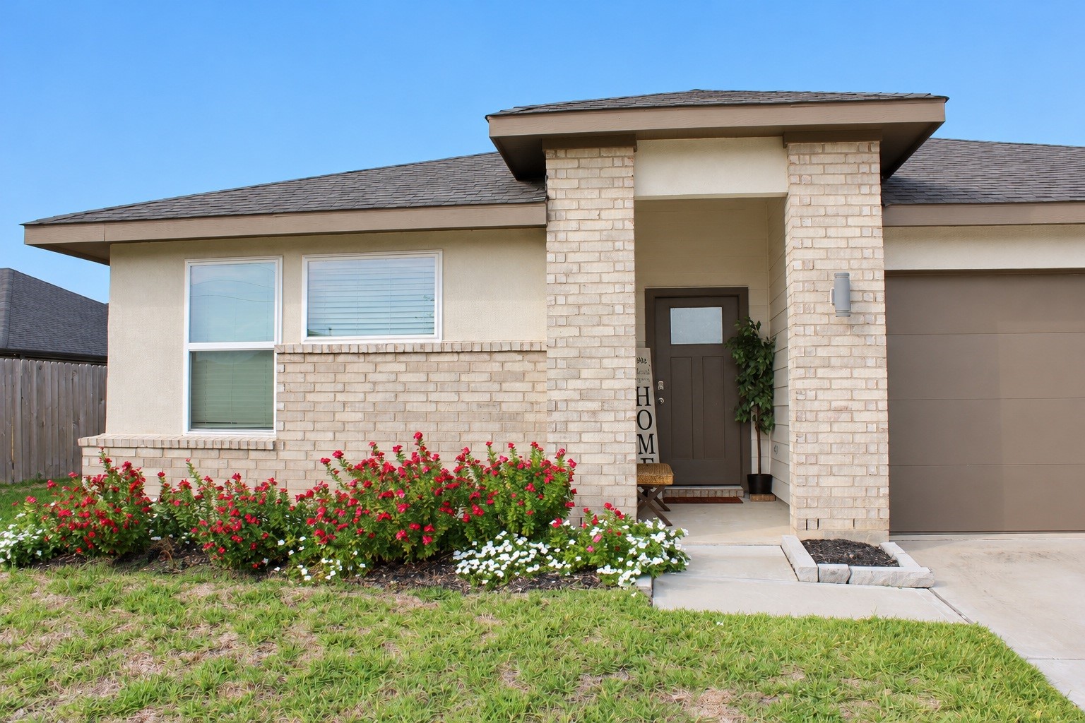 Front Entrance with Charming Brick Exterior and Colorful Landscaping.