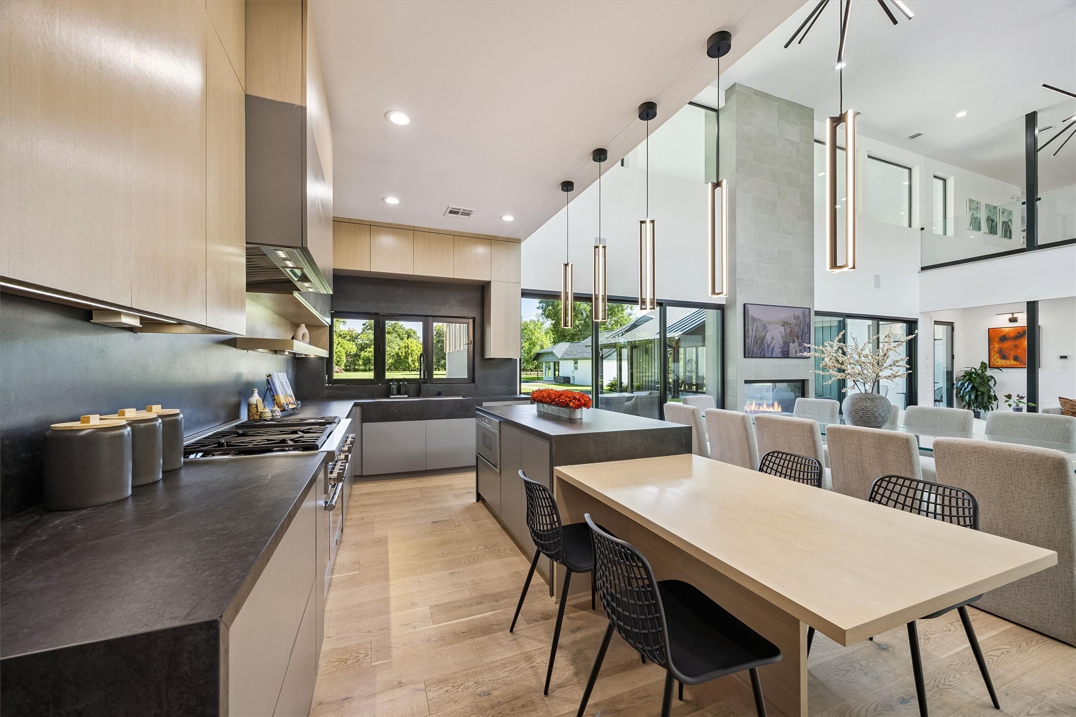 Designed for culinary creativity and effortless entertaining, this beautifully appointed kitchen features sleek cabinetry, expansive preparation surfaces, and a generous island overlooking the home's impressive living spaces.