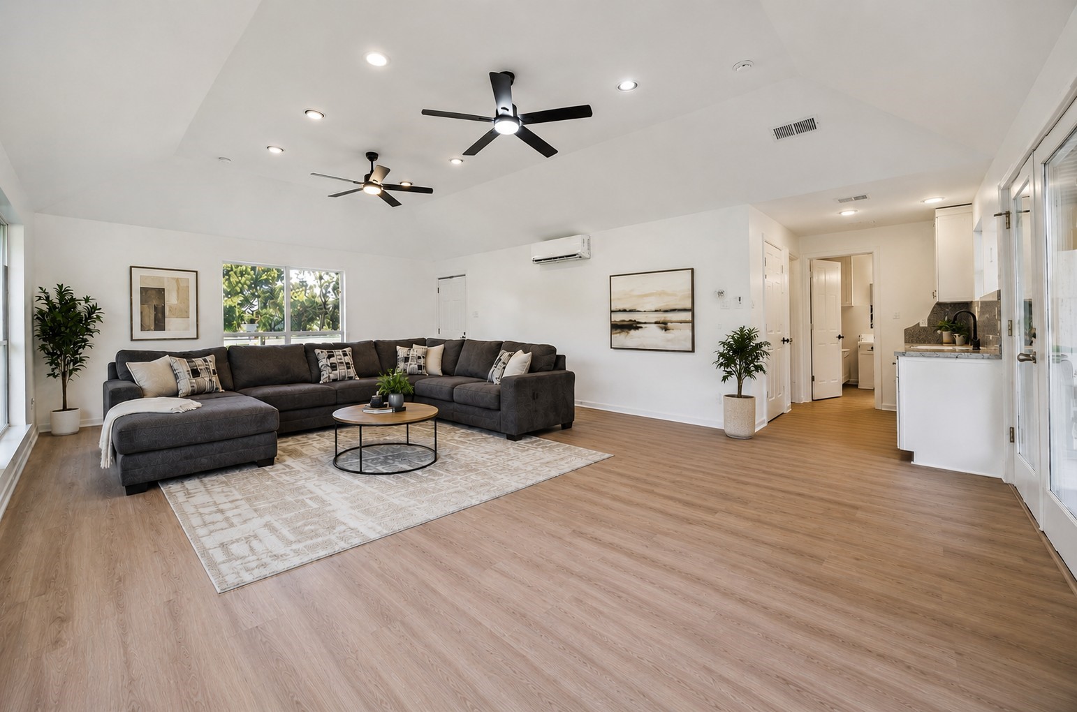 The detached pool house provides a welcoming retreat for guests and entertaining, with a spacious living area, contemporary finishes, and the convenience of its own kitchen.