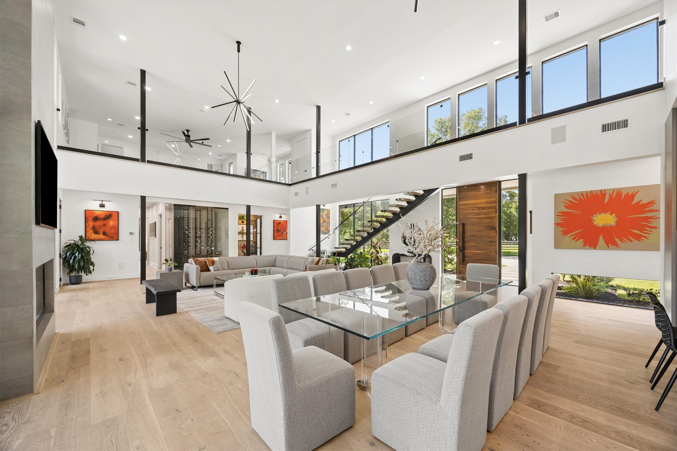 Soaring ceilings, sleek glass balustrades, and a sculptural staircase introduce a remarkable sense of scale, complemented by sophisticated finishes and elegant contemporary furnishings. Soaring ceilings, sleek glass balustrades, and a sculptural staircase introduce a remarkable sense of scale, complemented by sophisticated finishes and elegant contemporary furnishings.