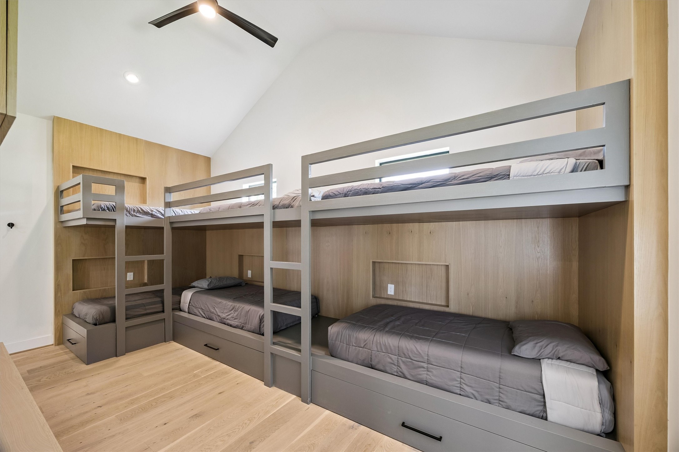 Designed with flexibility and fun in mind, this exceptional bunk room features custom-built accommodations for up to eight, creating a memorable space for family gatherings and overnight guests.