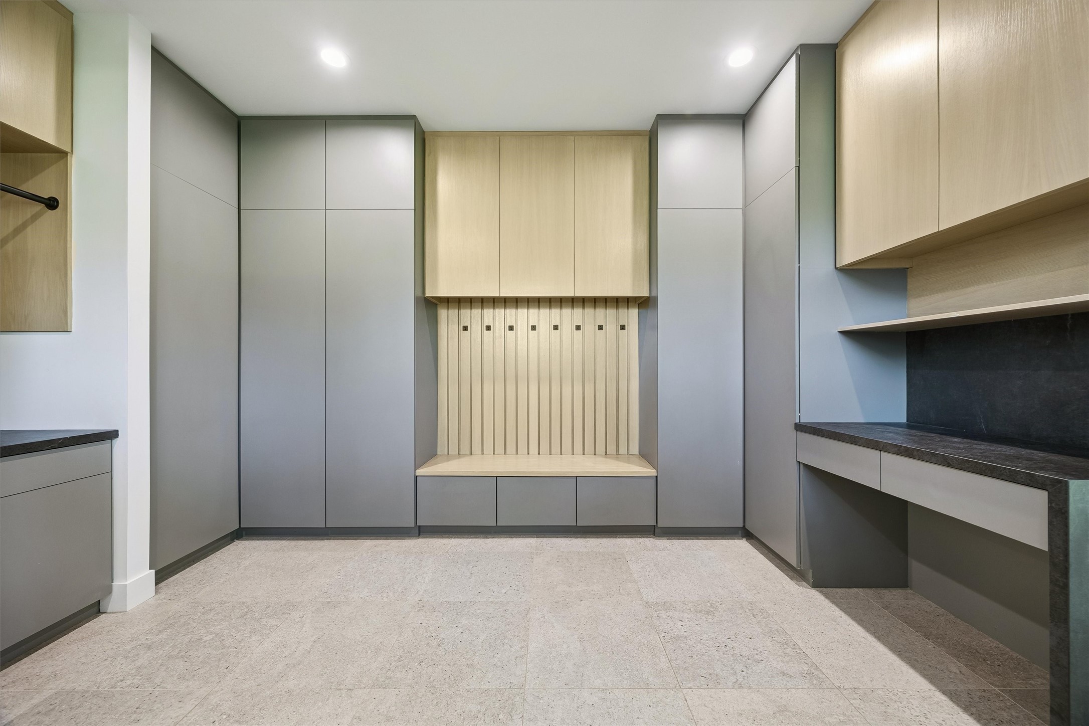 Thoughtfully designed for everyday convenience, the custom mudroom features extensive built-in cabinetry, concealed storage, and a welcoming bench that keeps daily essentials beautifully organized.
