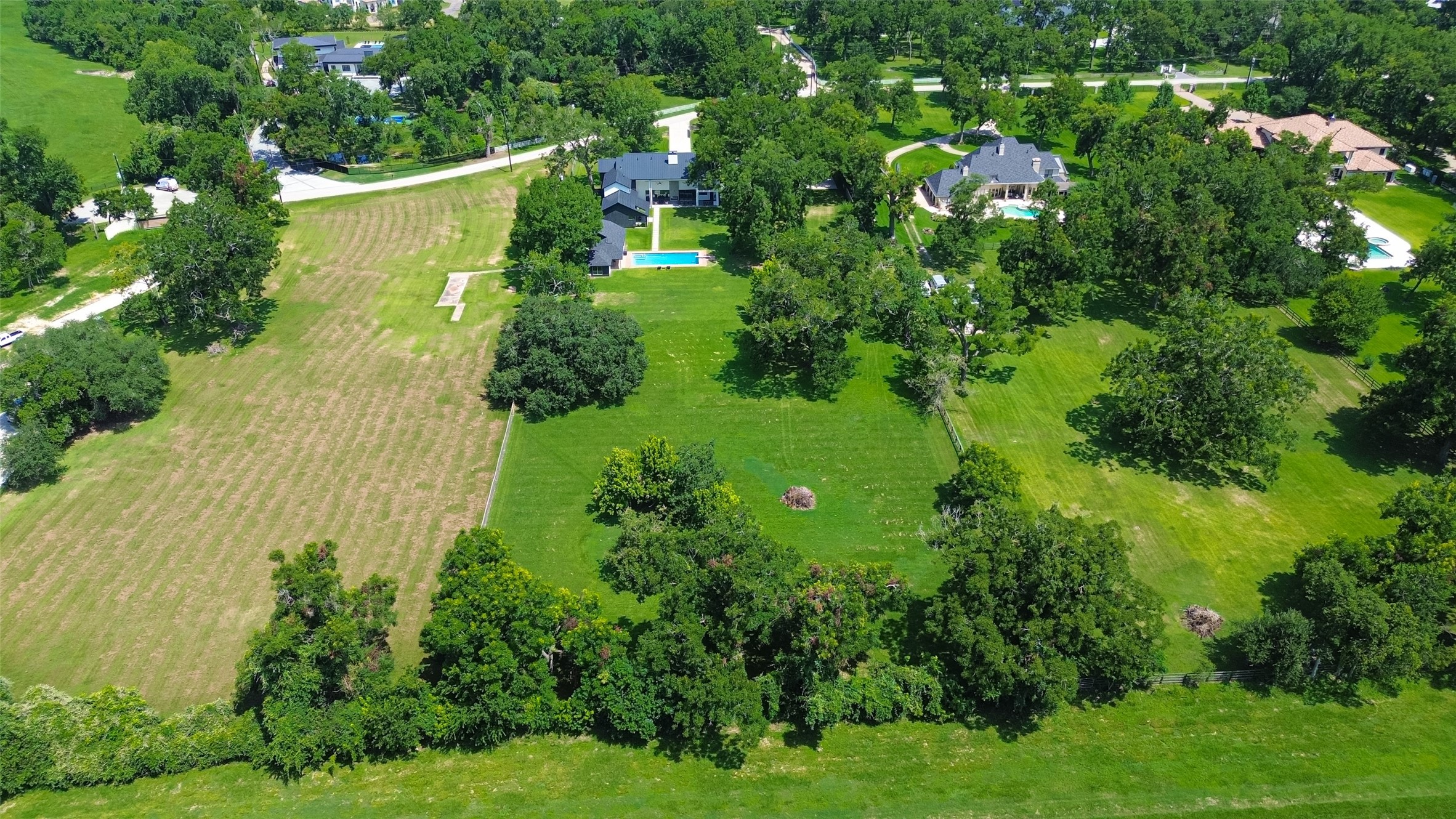 A breathtaking aerial view reveals the extraordinary scale and privacy of this nearly 3.9-acre estate, offering an exceptional opportunity to enjoy expansive grounds and refined living in the heart of Sugar Land.