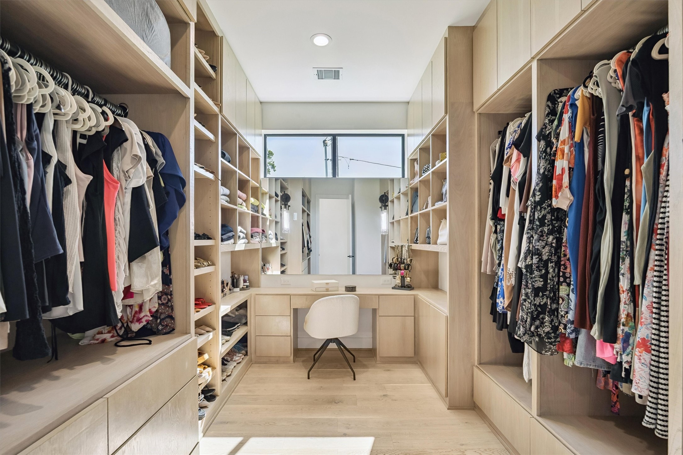 An exceptional dressing room offers beautifully organized wardrobe storage, extensive built-in cabinetry, and a dedicated vanity, bringing boutique-inspired elegance to everyday living.