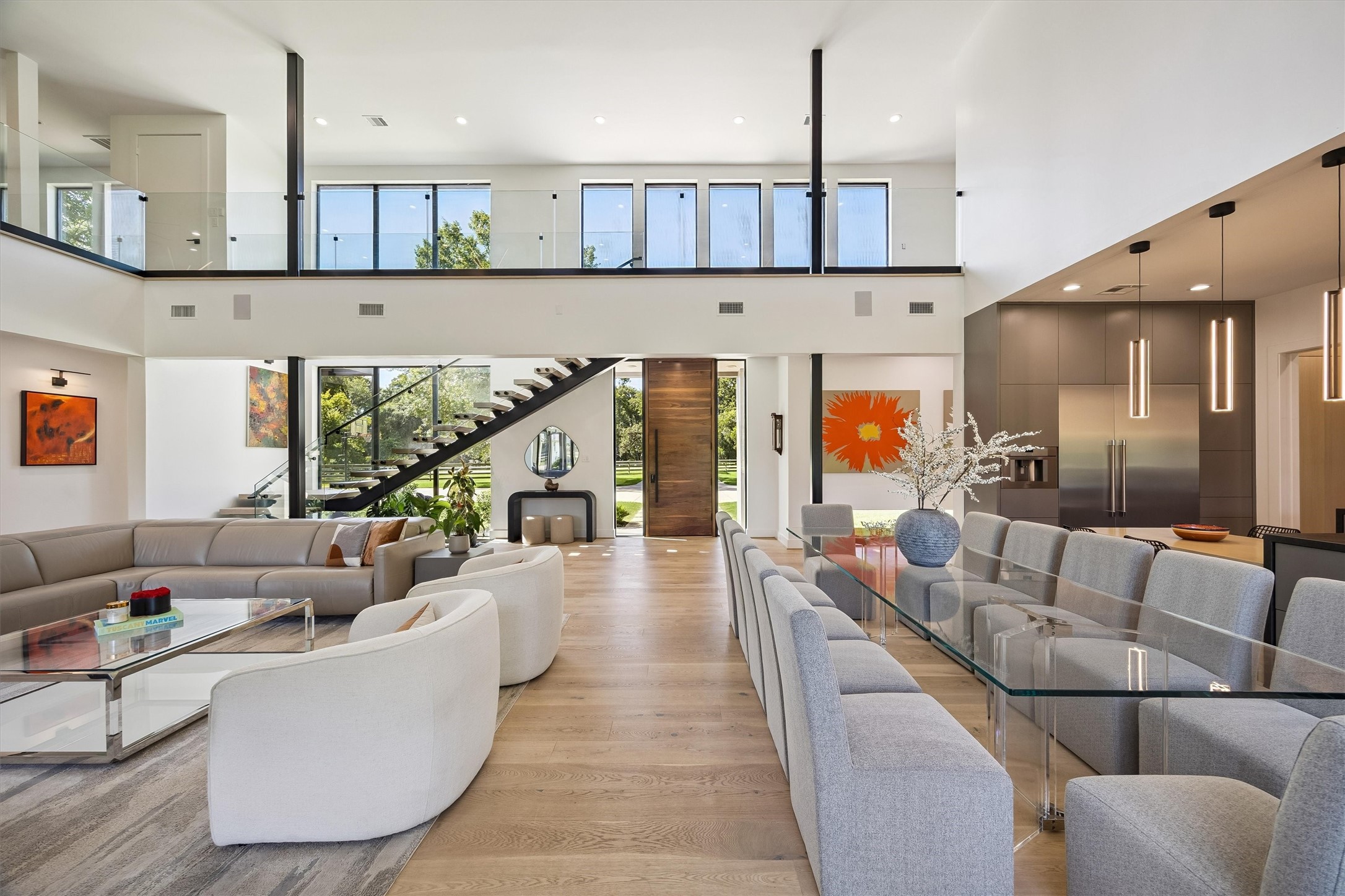 Breathtaking two-story interiors unfold beneath soaring ceilings, where contemporary design, dramatic glass railings, and thoughtfully connected living spaces create an extraordinary setting for entertaining. Breathtaking two-story interiors unfold beneath soaring ceilings, where contemporary design, dramatic glass railings, and thoughtfully connected living spaces create an extraordinary setting for entertaining.