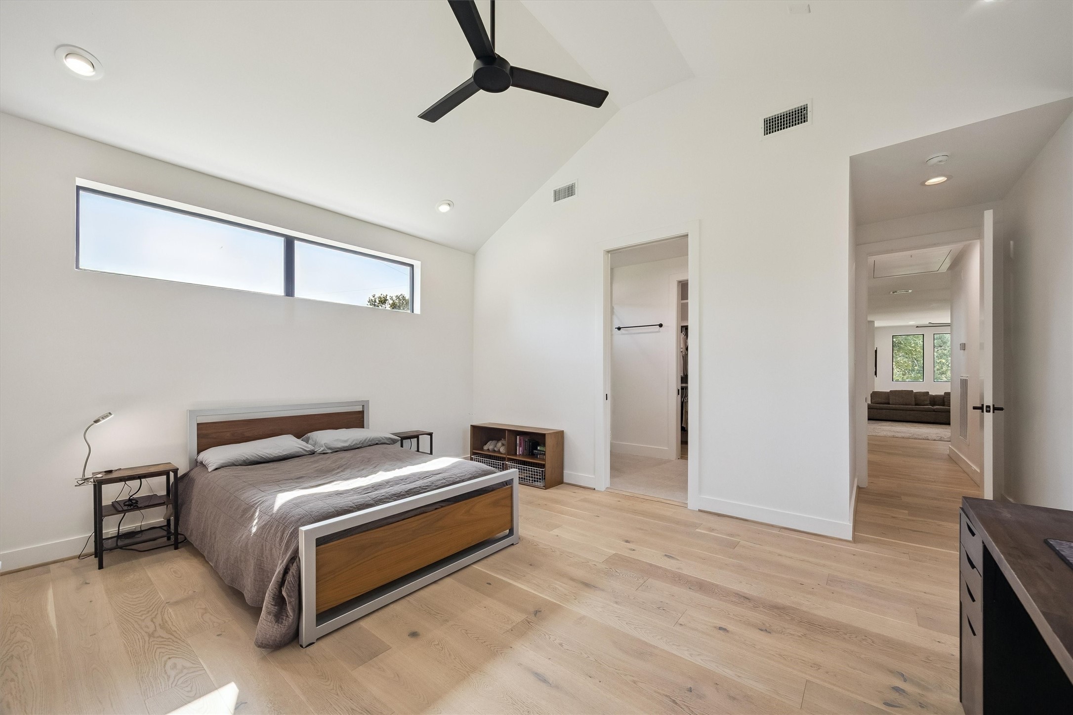 Vaulted ceilings, contemporary finishes, and thoughtfully positioned windows create an airy, welcoming bedroom designed for restful nights and quiet moments.