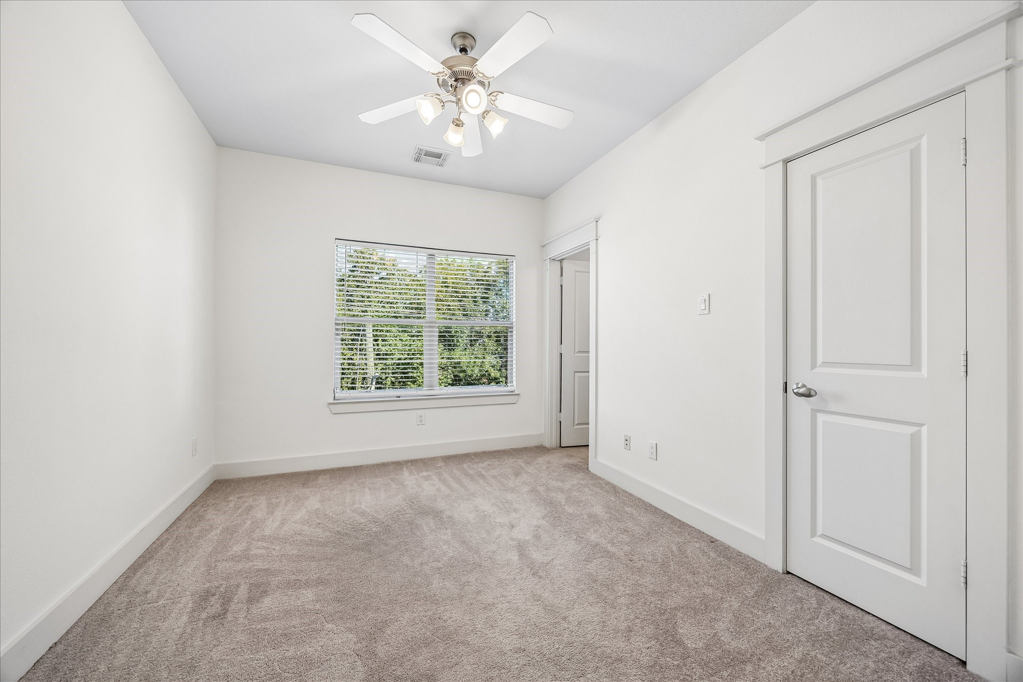 The third bedroom on the third floor features a closet and ensuite bathroom