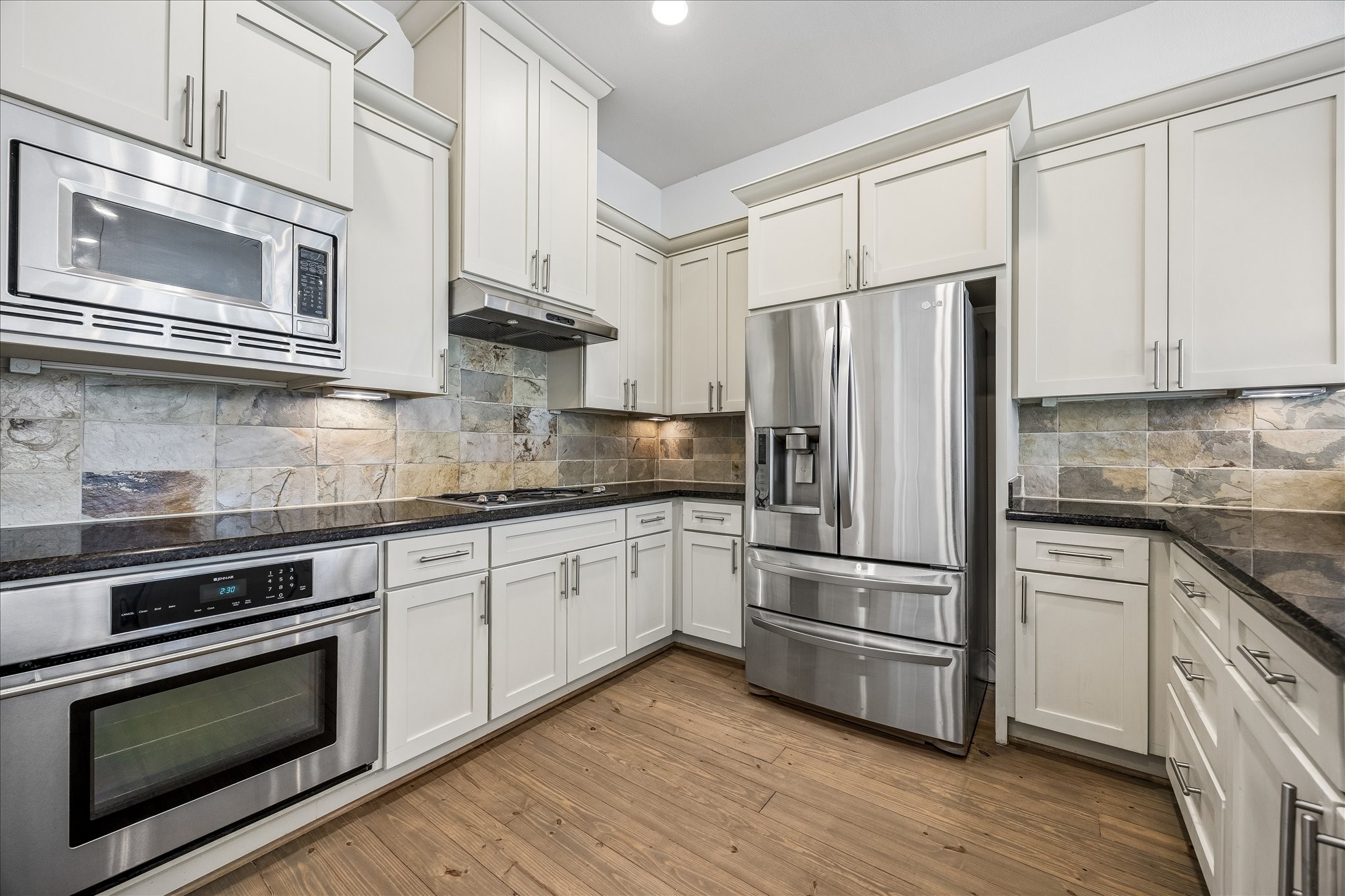 The kitchen features stainless steal appliances, a gas stove, and the refrigerator is included with the lease