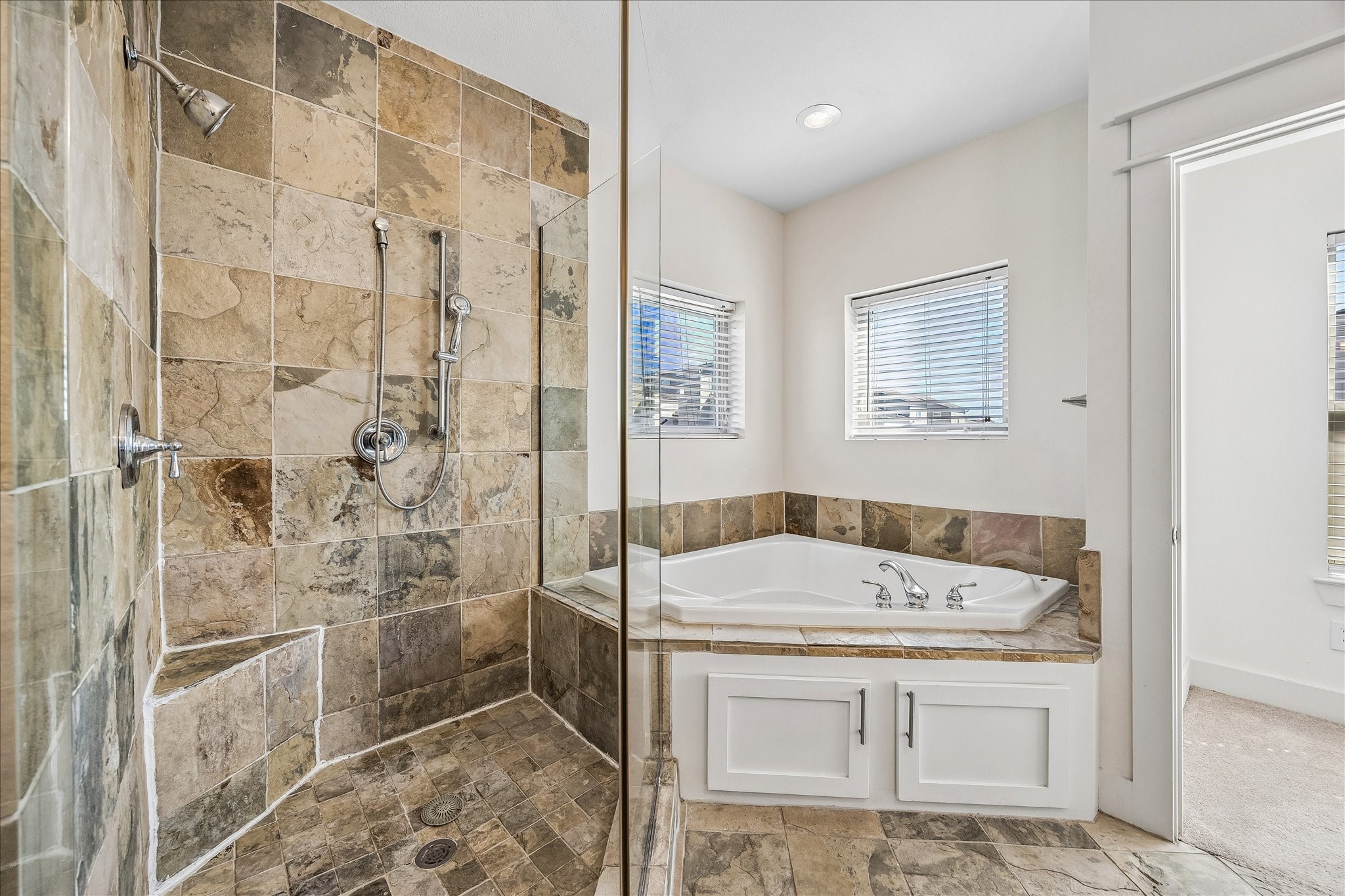 The primary bathroom also has a walk-in shower and large bathtub for those long days