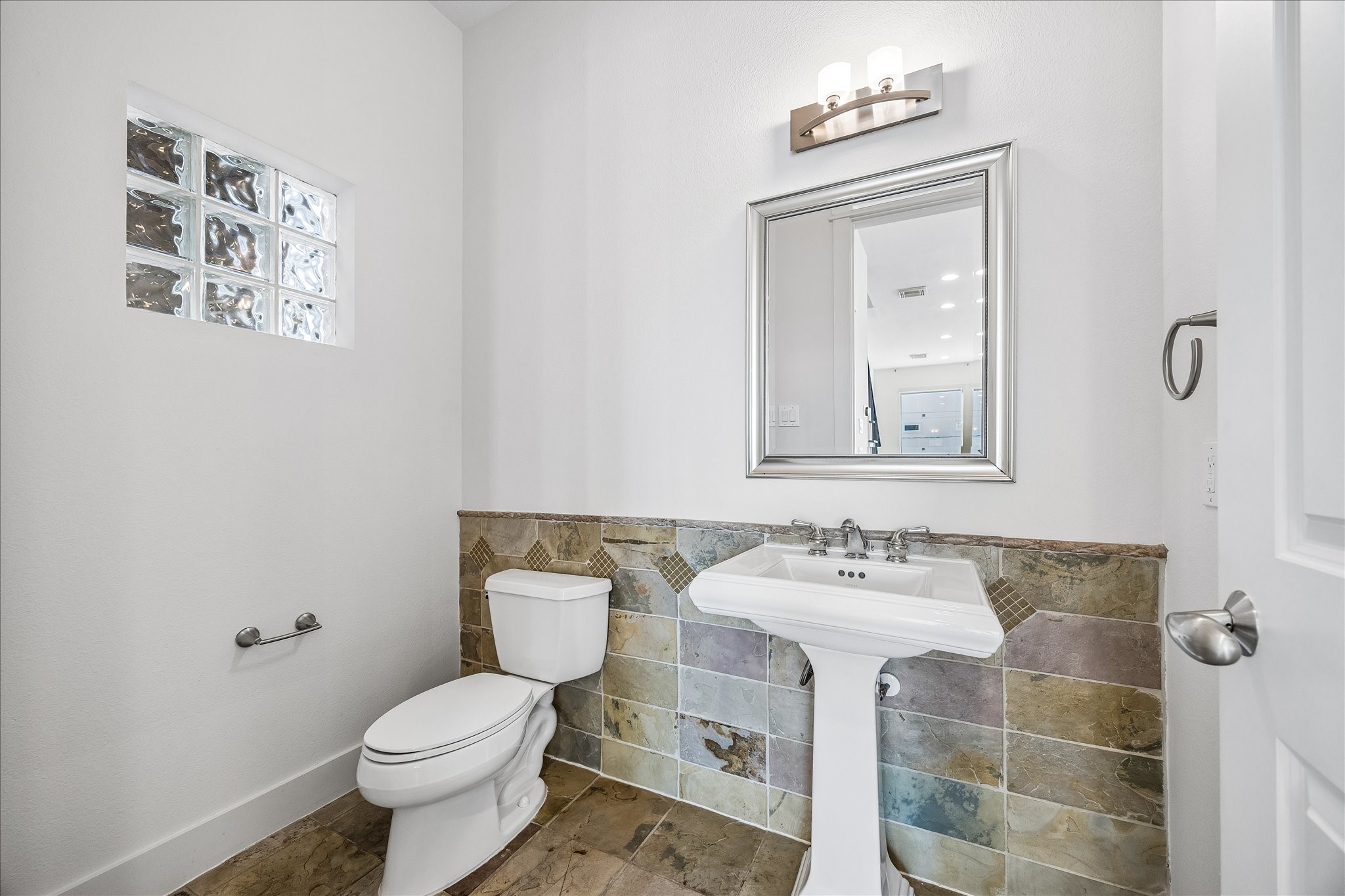 Off the kitchen, conveniently located on the second floor is a half bath for guests