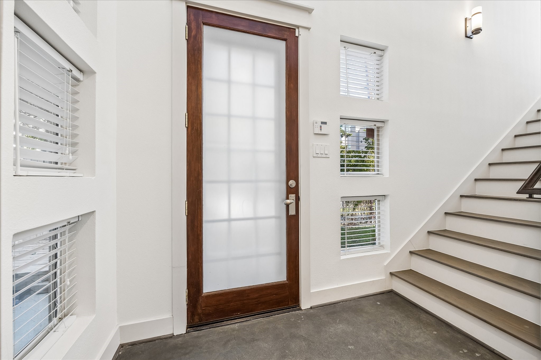 The front entry leads to the second floor, the garage, and the first-floor bedroom