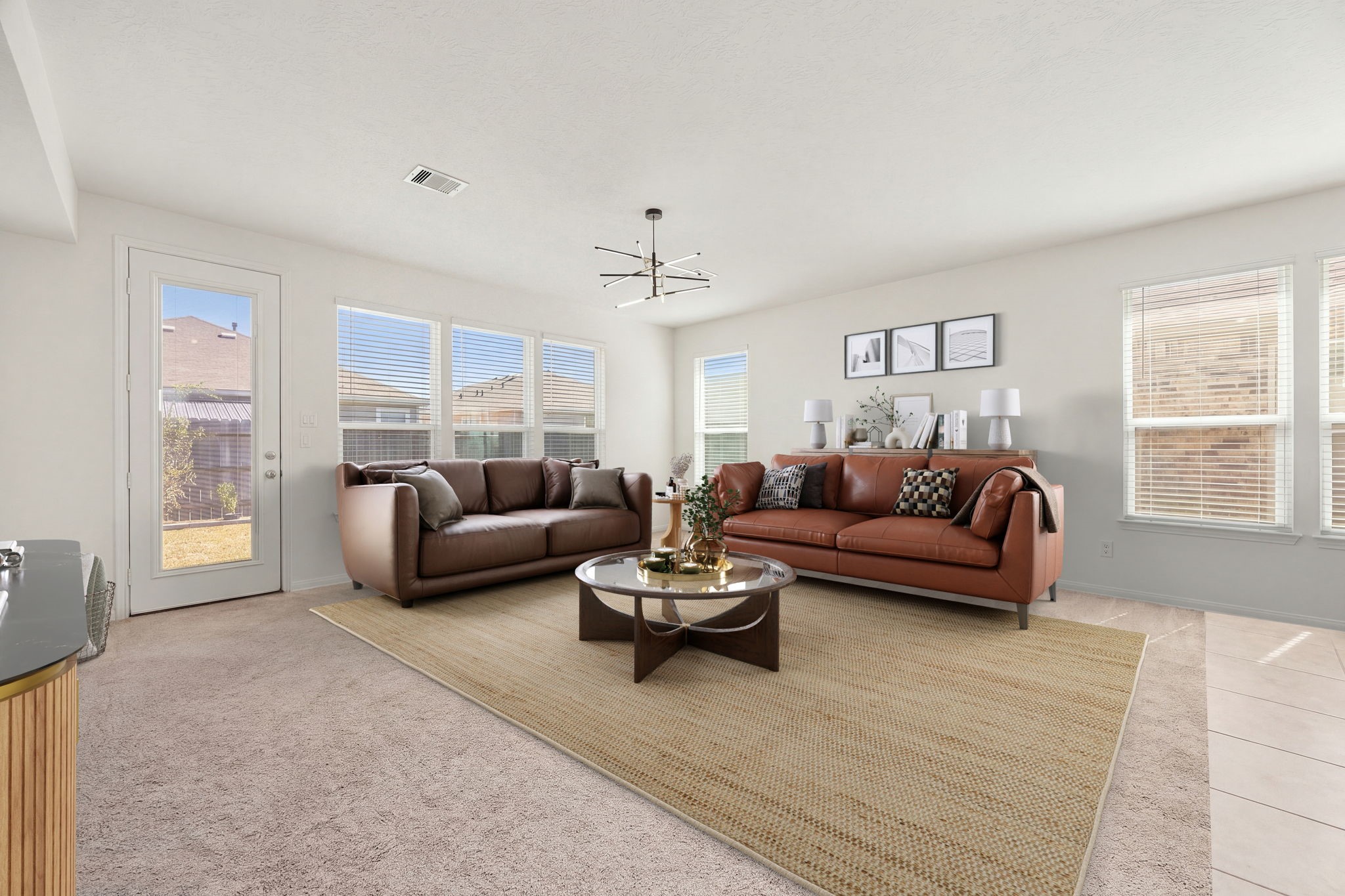 Perfect for relaxing or entertaining guests, this airy living zone seamlessly flows into the adjacent dining area and kitchen hub. The clean white walls and soft neutral carpeting create a versatile backdrop, while direct glass-door access to the backyard makes indoor-outdoor transitions effortless.