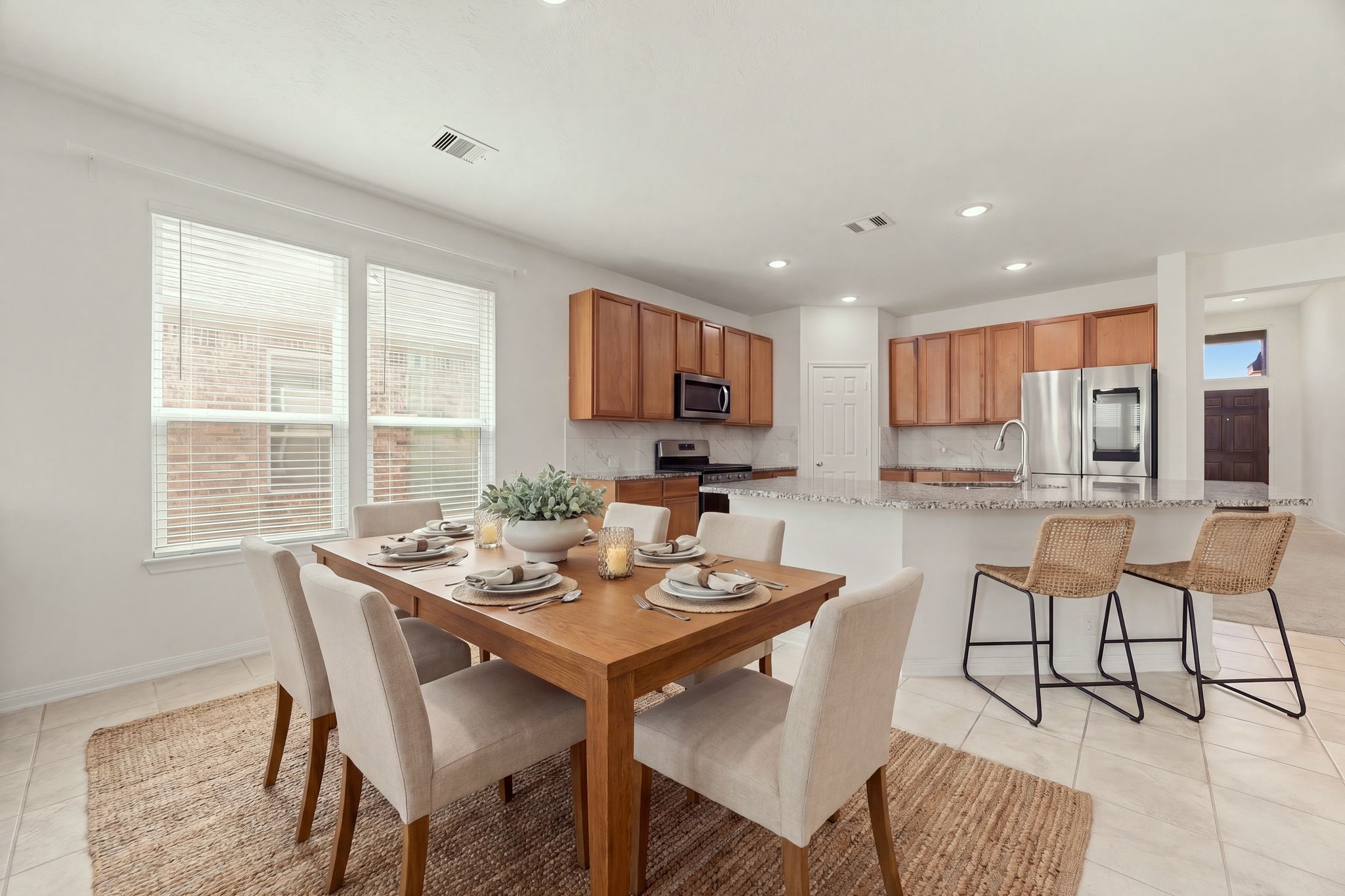 The dedicated casual dining area serves as a beautiful transition space within the open-concept layout. Oversized windows with custom drapery flood the space with natural light, making it a bright and cheerful setting for daily family meals or intimate dinner parties. *Virtually Staged