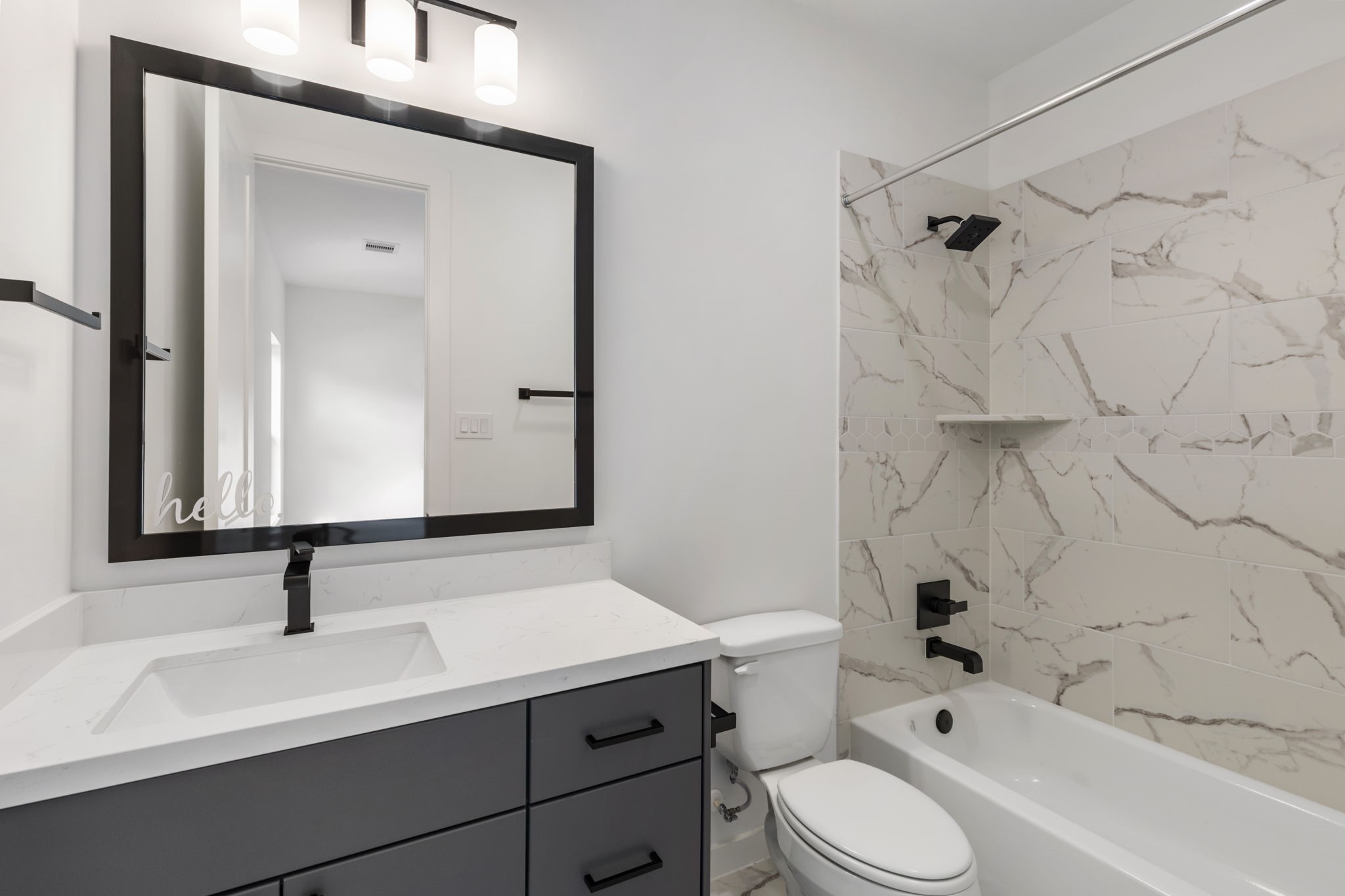 Ensuite with shower and bathtub combo.