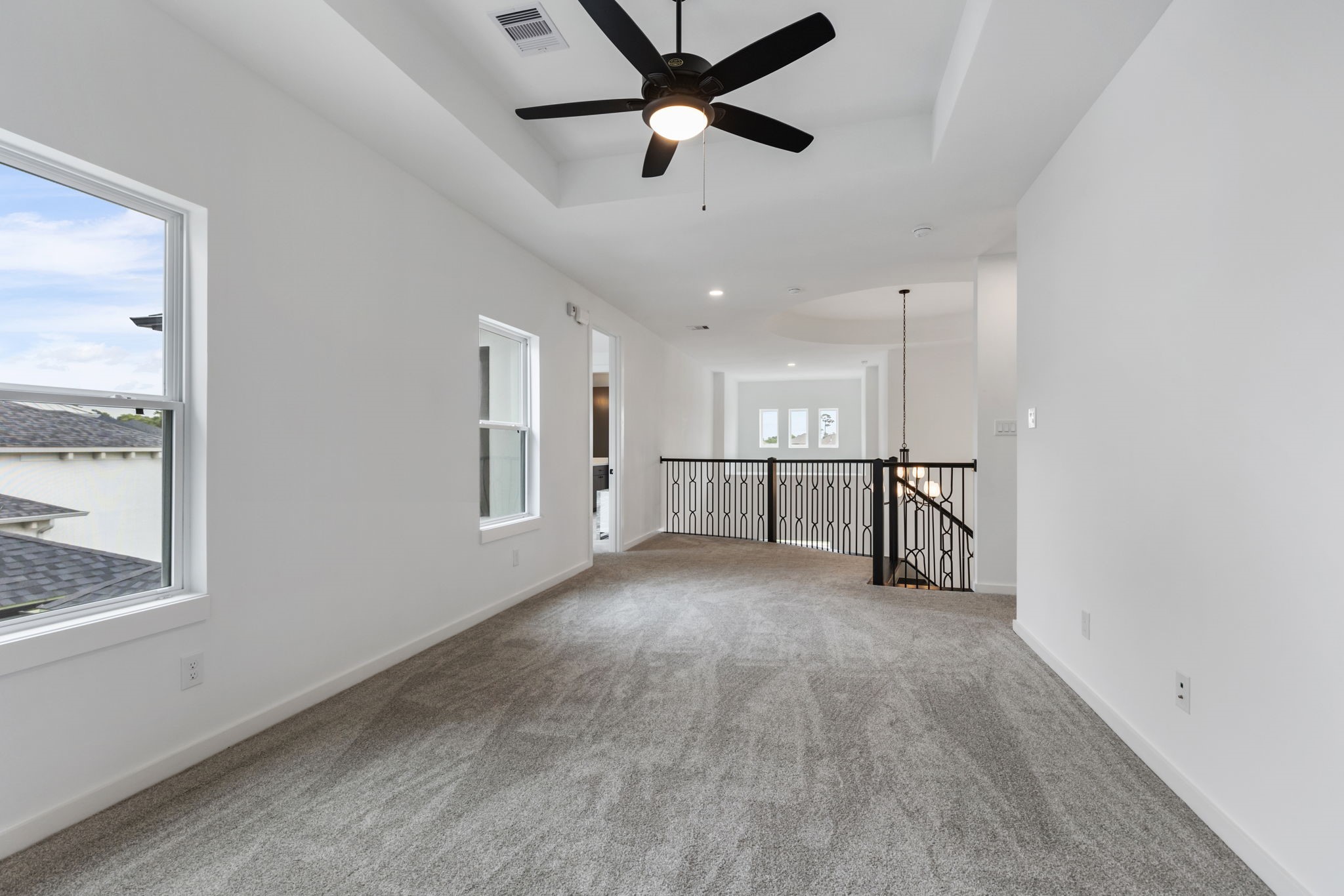 Game room on second floor with tray ceilings.