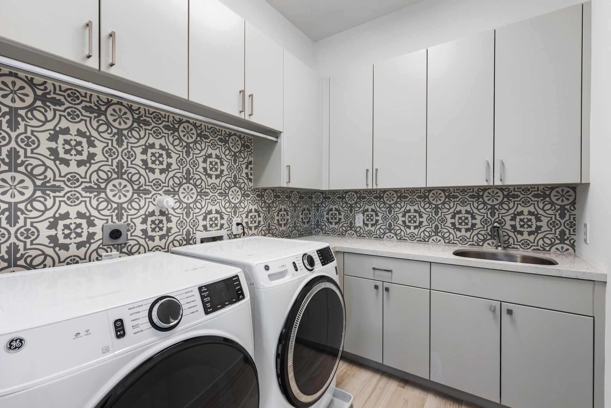 Large utility room with a sink and ample storage space.