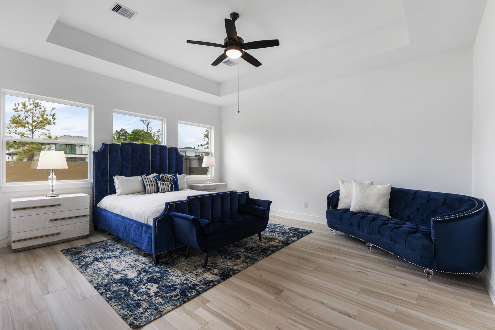 Primary bedroom with tray ceilings.