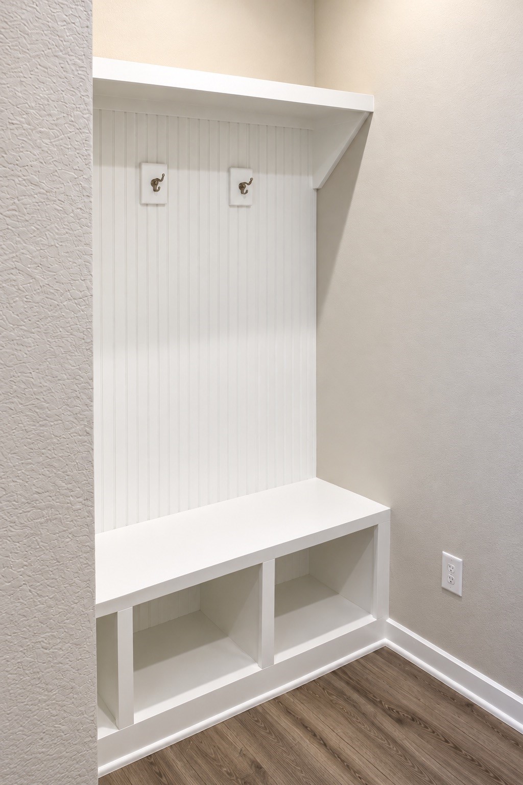 Convenient mudroom area featuring a built-in bench, storage cubbies, and hooks for everyday essentials. A practical drop zone to help keep things organized.
