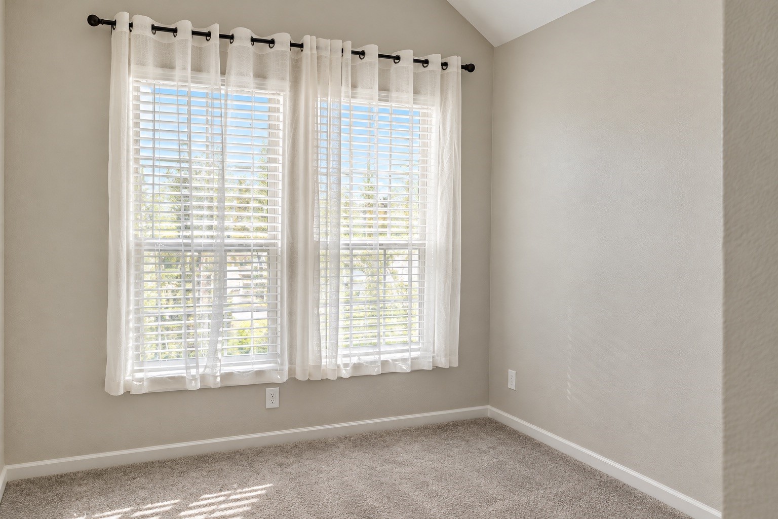 A second bedroom downstairs offers added convenience and flexibility for guests, family, or everyday living.