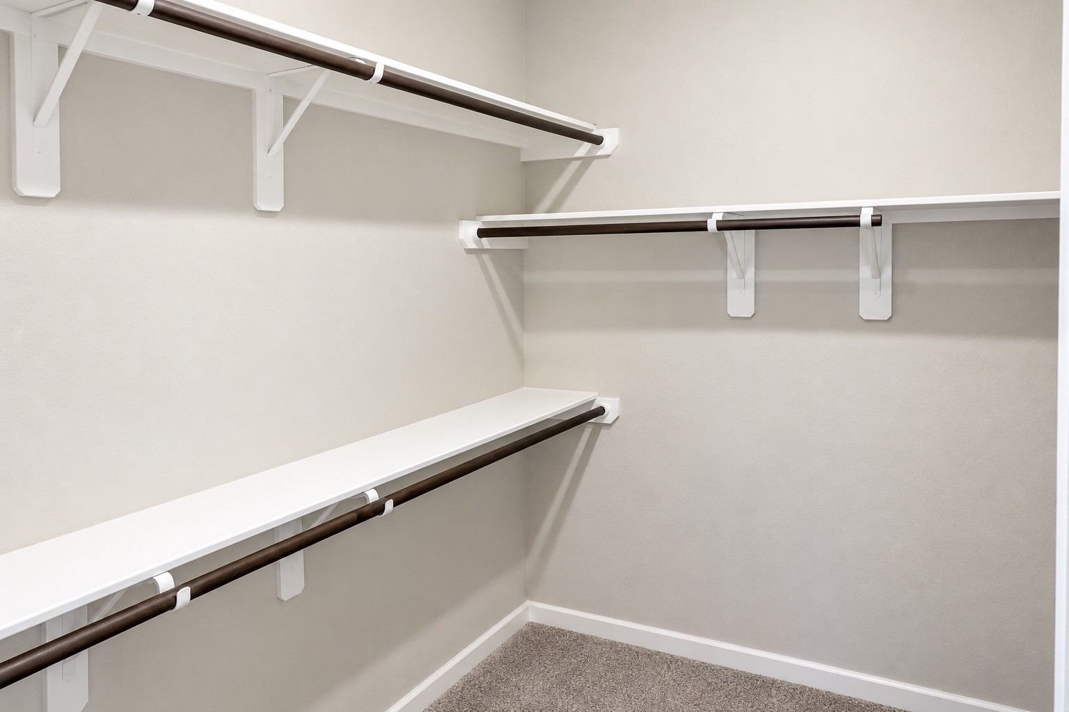 Sizable primary walk-in closet featuring ample hanging space and built-in shelving, offering plenty of room for clothing, shoes, and accessories.