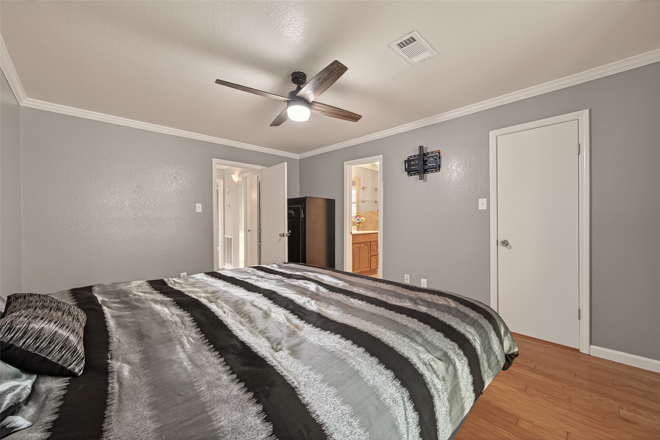 Generously sized Primary bedroom with crown molding and enough space for a king or a queen!