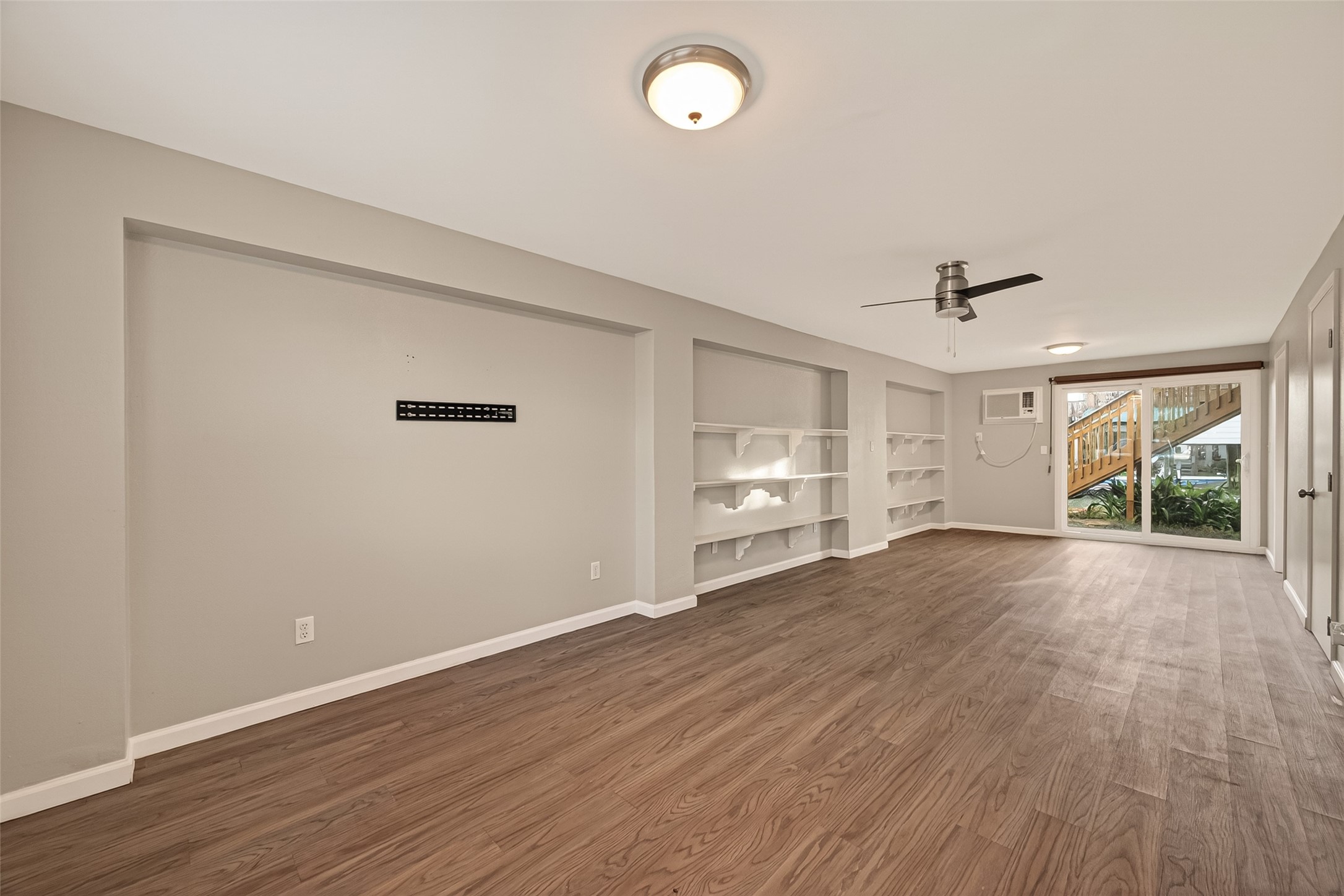 Another view of the multifunctional bedroom / game room down stairs with strong, attractive patio doors leading to the backyard.