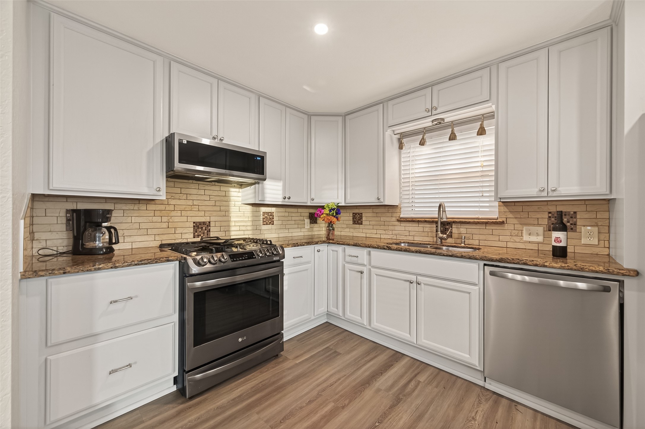 Beautiful kitchen with attractive granite countertops and stylish backsplash.