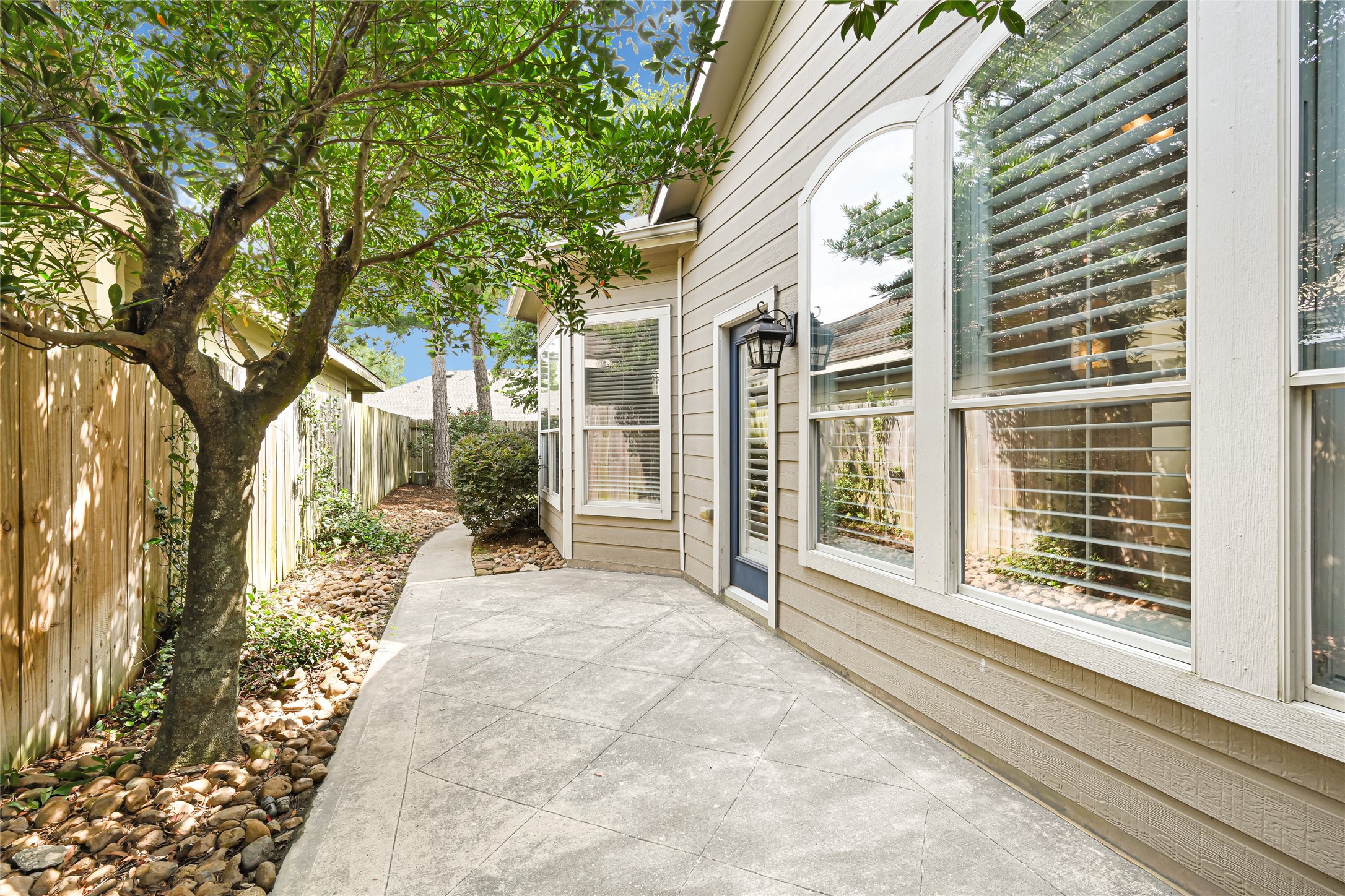 Inviting walkway guides you to the private backyard retreat.