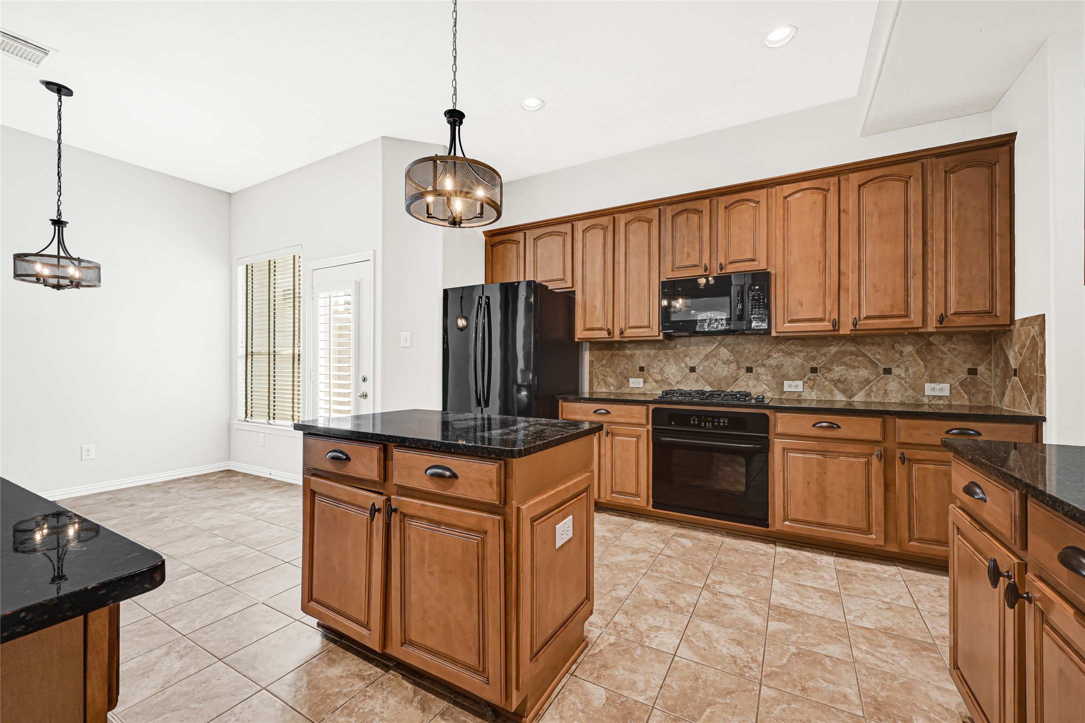 Stunning cabinetry complements the open-concept design, connecting the kitchen to a charming breakfast area.