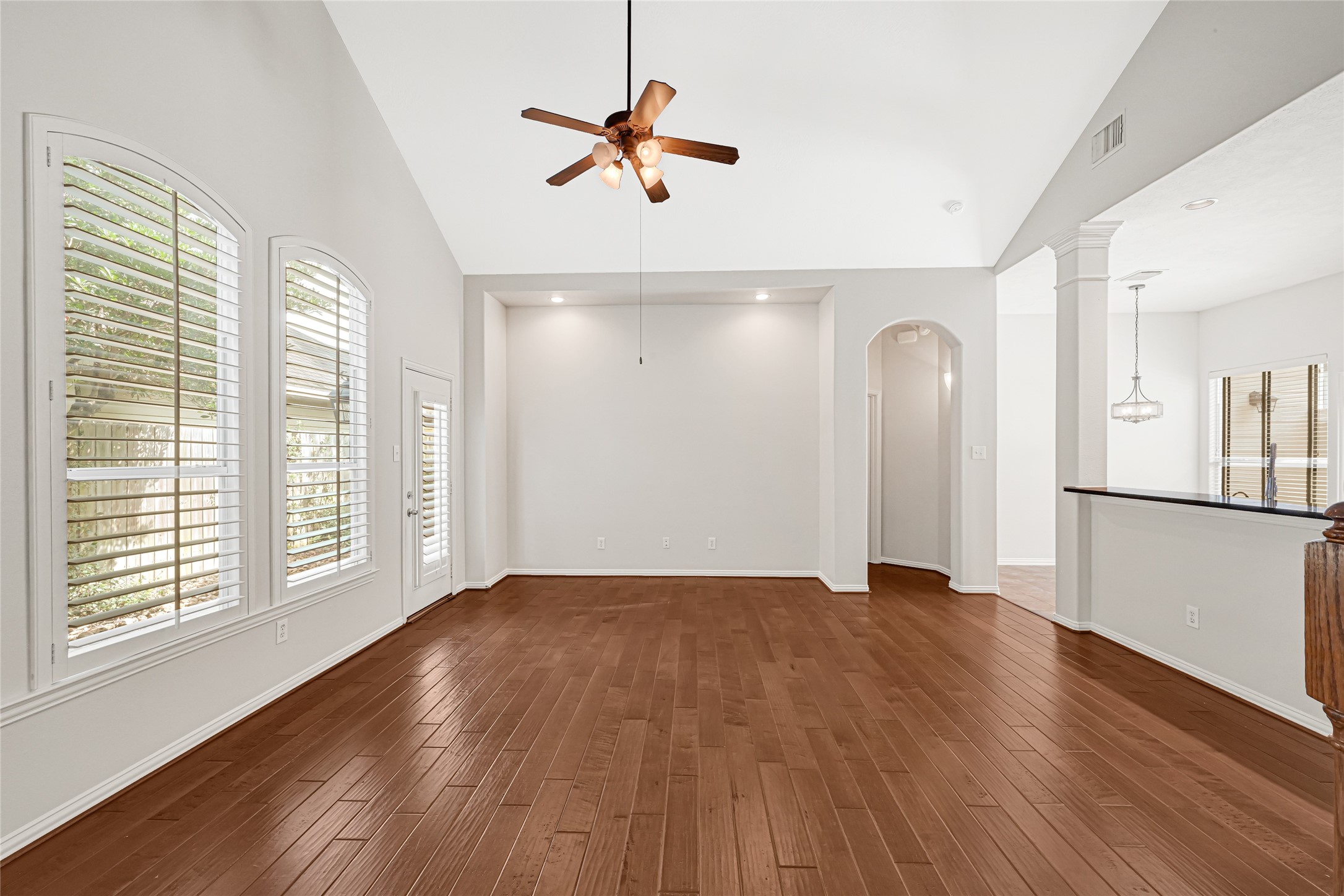 Family room, with plantation shutters and side door leading to the backyard.