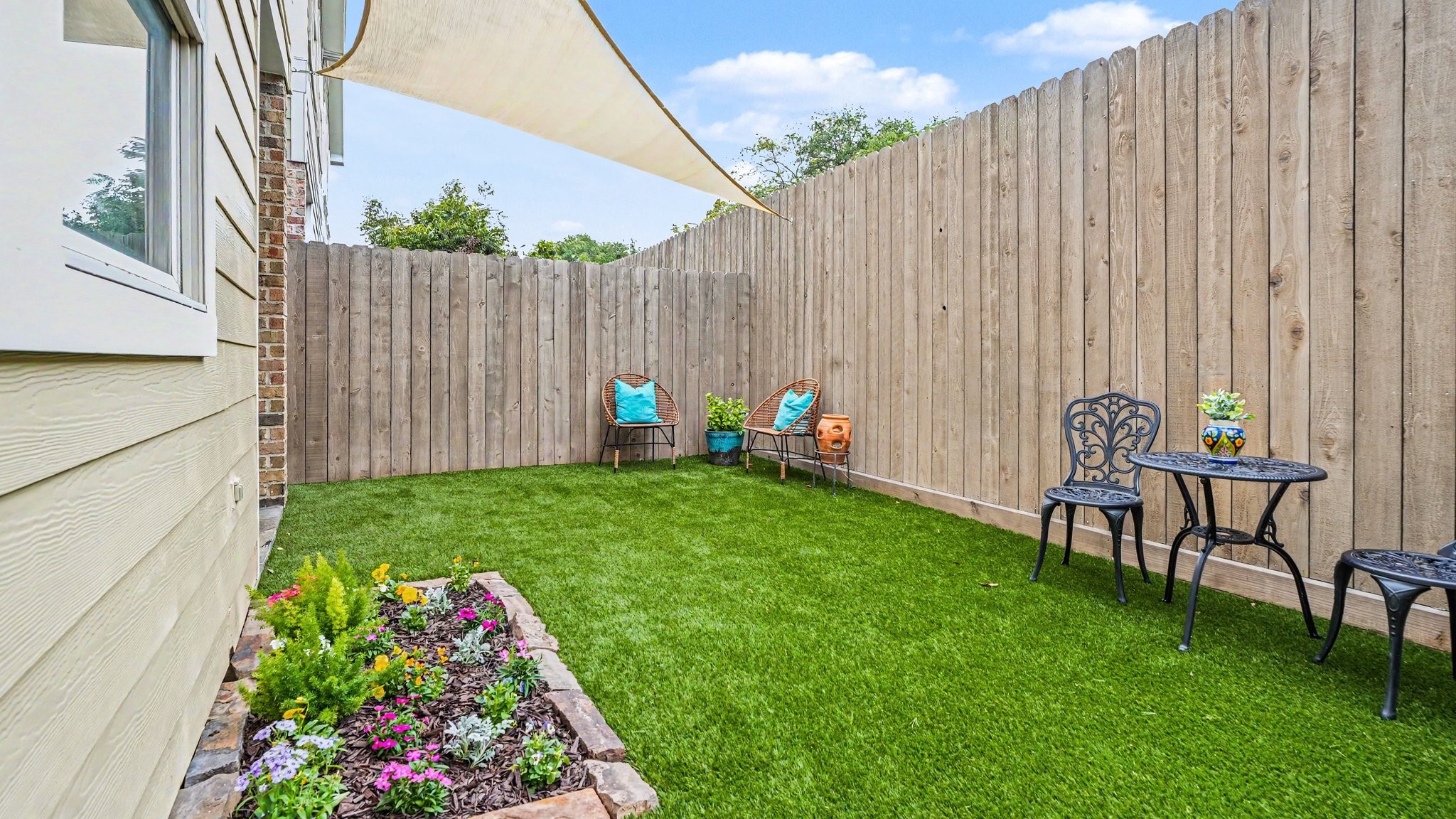 Brand new turfed backyard with flower bed and sail shade. Fully fenced.